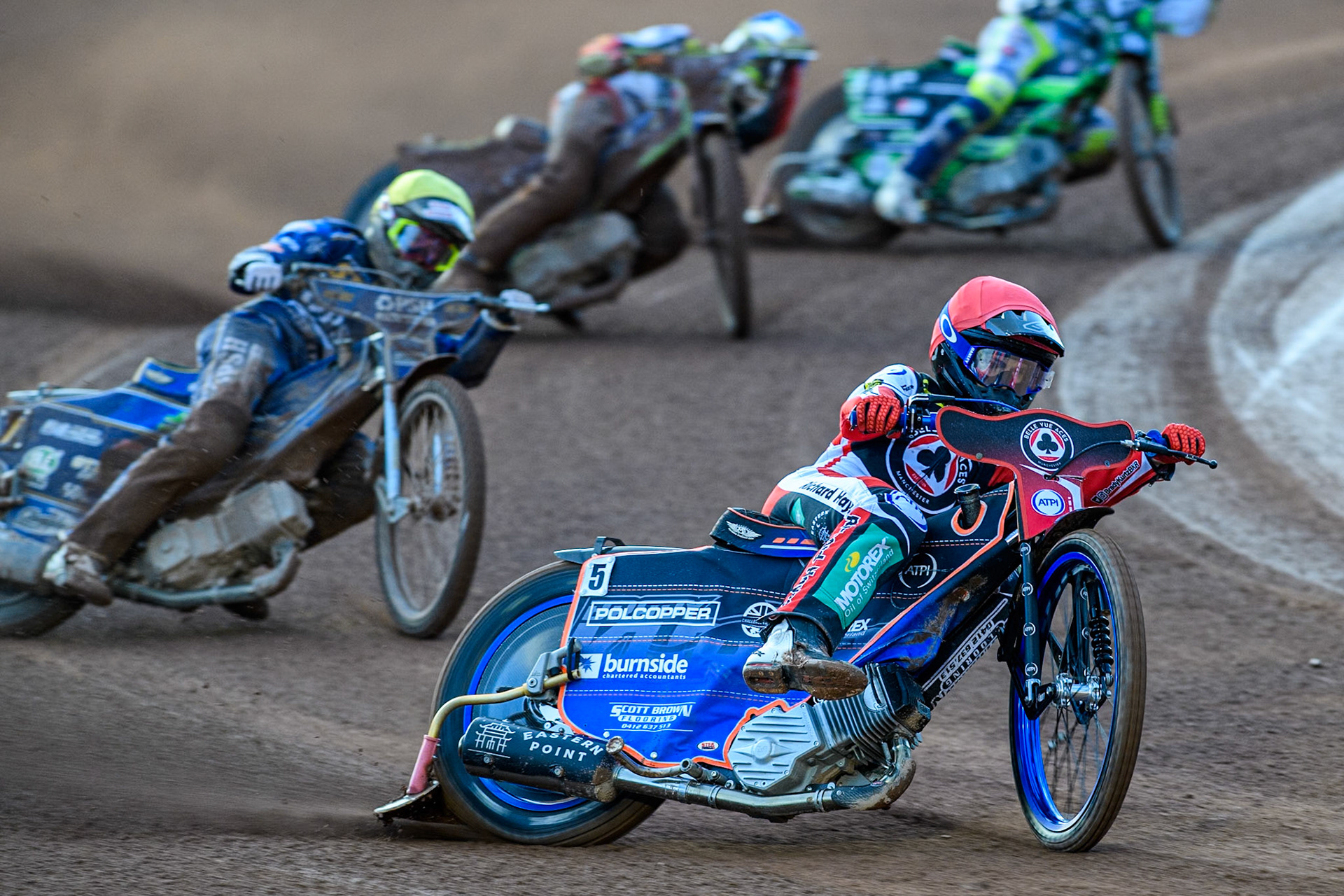 Belle Vue Aces' Brady Kurtz  in Red leading Kings Lynn Stars' Anders Rowe  in Yellow and Belle Vue Aces' Jake Mulford  in Blue during the Rowe Motor Oil Premiership match between Belle Vue Aces and King's Lynn Stars at the National Speedway Stadium, Manchester on Monday 12th August 2024. (Photo: Ian Charles | MI News)