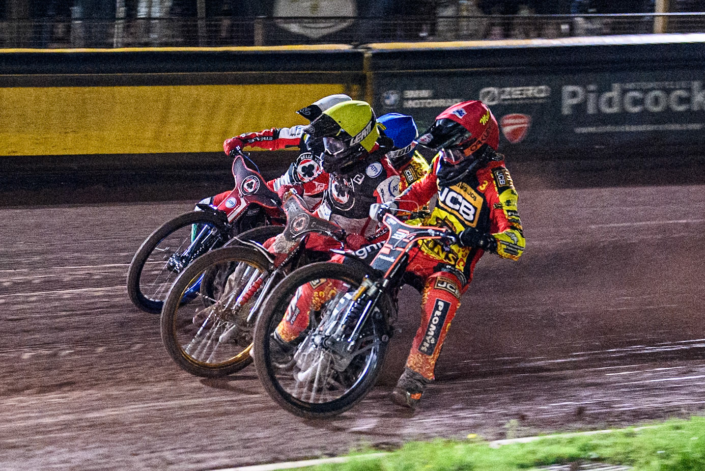 Leicester Lions' Sam Masters in Red rides inside Belle Vue Aces' Norick Blodorn in Yellow, Leicester Lions' Luke Becker in Blue and Belle Vue Aces' Brady Kurtz in White during the Rowe Motor Oil Premiership Grand Final 2nd Leg between Leicester Lions and Belle Vue Aces at the Pidcock Motorcycles Arena, Leicester on Thursday 26th September 2024. (Photo: Ian Charles | MI News)