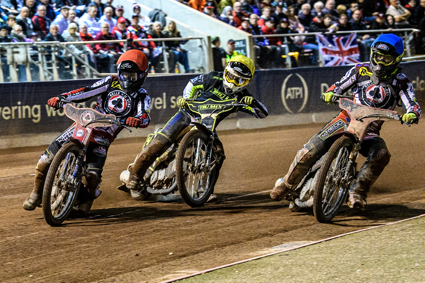 Brady Kurtz (Red) and Tom Brennan (Blue) lead Danyon Hume (Yellow) during the Sports Insure Premiership Semi Final Playoff 2nd leg match between Belle Vue Aces and Ipswich Witches at the National Speedway Stadium, Manchester on Monday 25th September 2023. (Photo: Ian Charles | MI News)