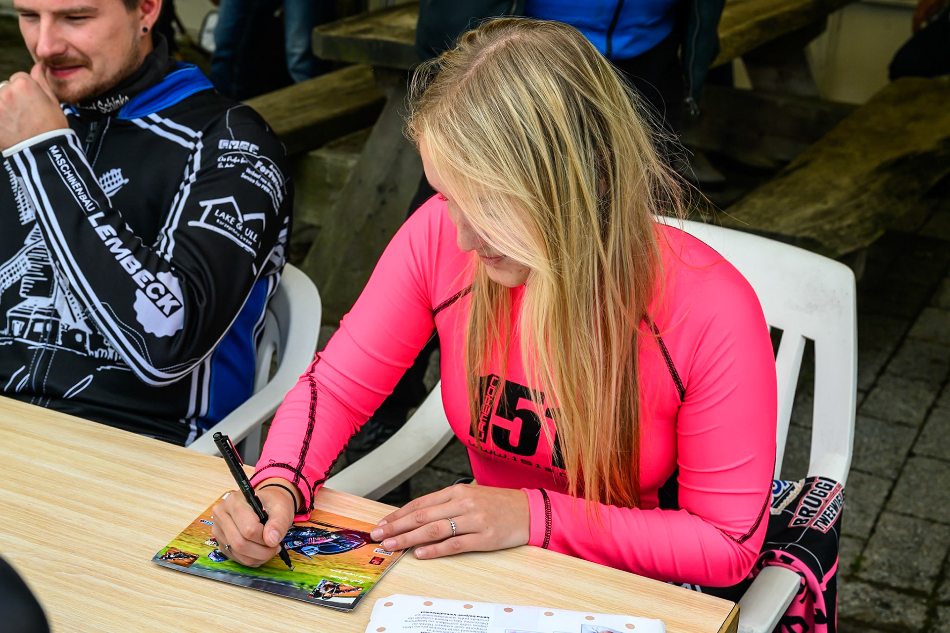 Reserve Rider Nynke Sijbesma (17) of The Netherlands signs an autograph during the FIM Long Track World Championship Final 4, at the Speed Centre Roden, Netherlands on Sunday 21st September 2025. (Photo: Ian Charles | MI News)
