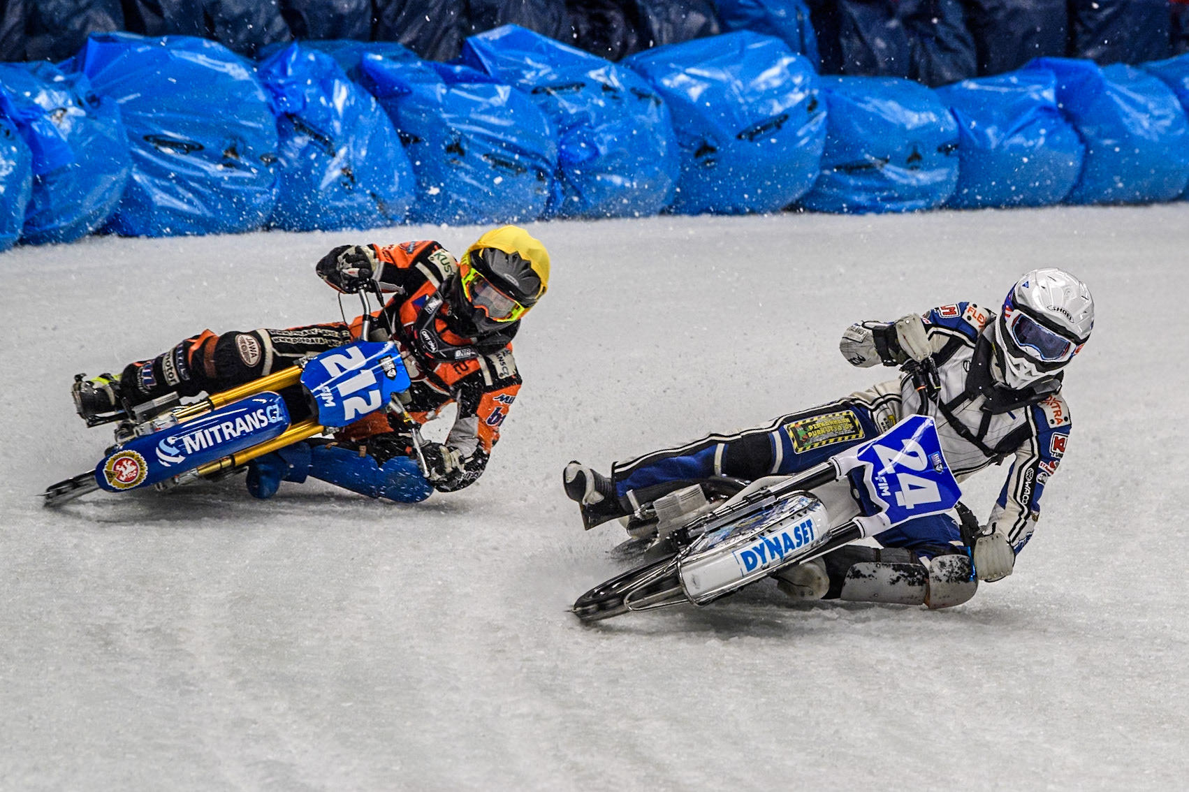 Max Koivula (24) of Finland in White rides inside Lukas Hutla (212) of the Czech Republic in Yellow during the Ice Speedway Gladiators World Championship Final 1 at Max-Aicher-Arena, Inzell on Saturday 15th March 2025. (Photo: Ian Charles | MI News)