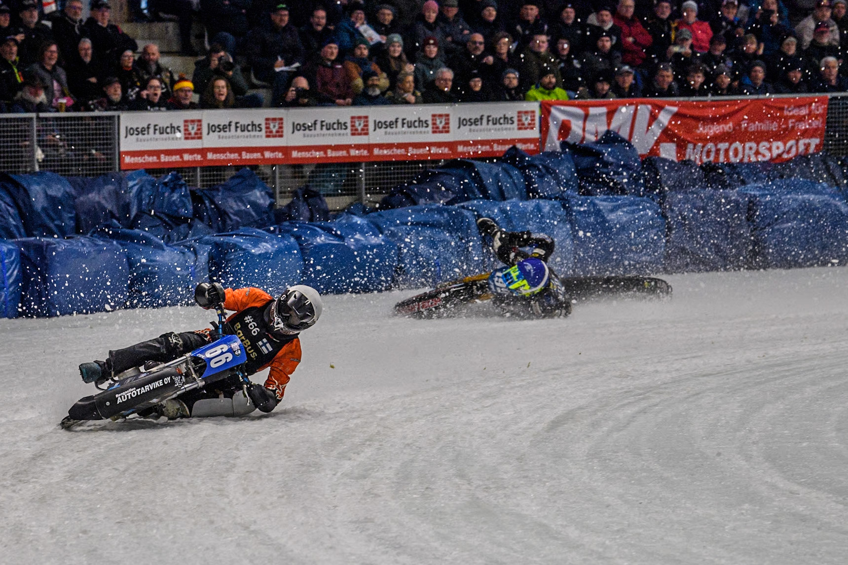 Finland's Aki Ala-Riihimäki (66) (White) leads  as Sweden's Martin Haarahiltunen (199)  (Blue) crashes out during the FIM Ice Speedway Gladiators World Championship Final 2 at the Max-Aicher-Arena, Inzell on Sunday 24 March 2024. (Photo: Ian Charles | MI News)