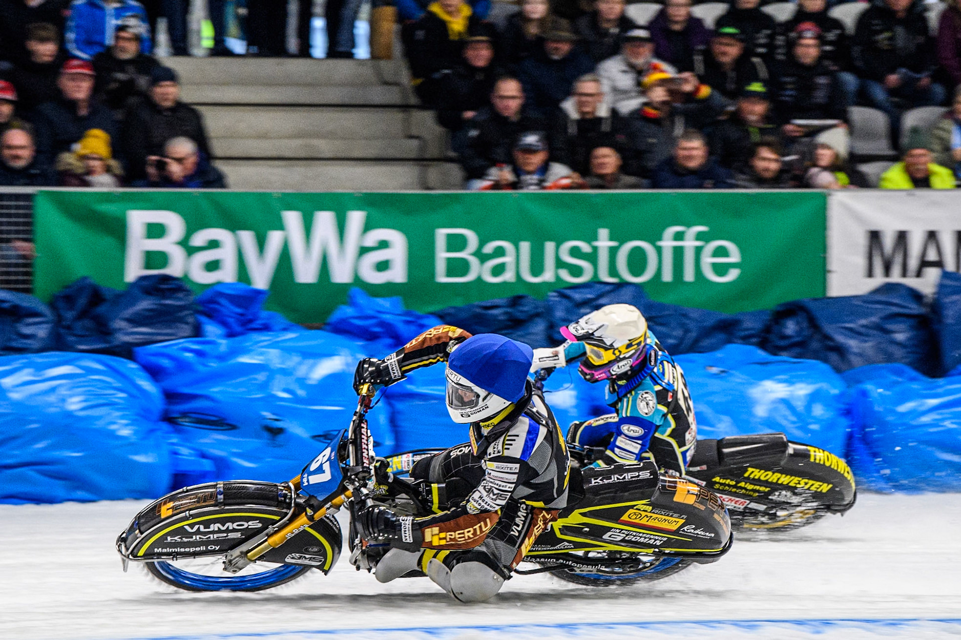 Heikki Huusko (67) of Finland in Blue rides inside \during the Ice Speedway Gladiators World Championship Final 2 at Max-Aicher-Arena, Inzell on Sunday 16th March 2025. (Photo: Ian Charles | MI News)48\ in Yellow