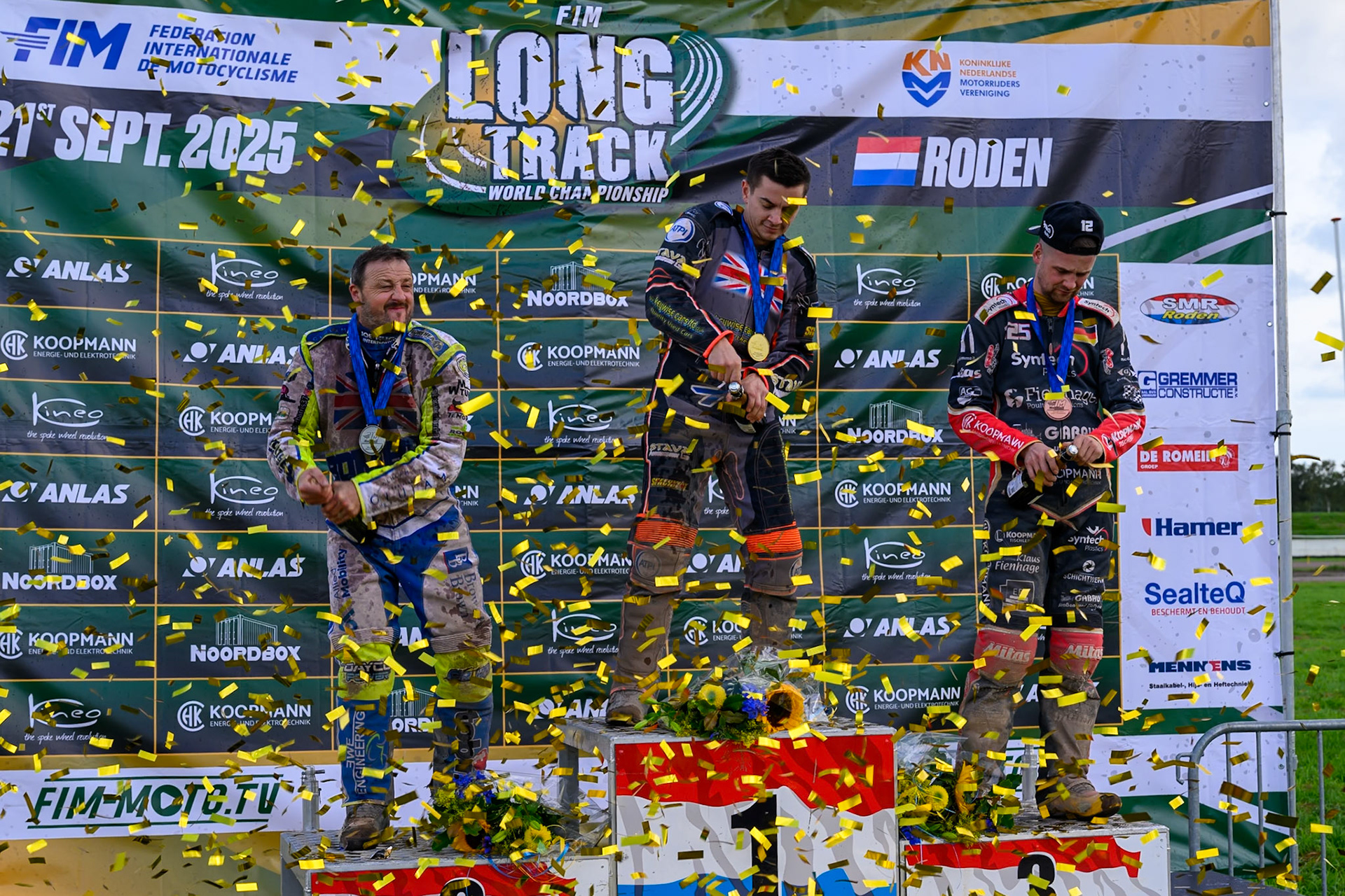 World Championships Rostrum Champagne Capers: (L to R) Chris Harris (2nd), Zach Wajtknecht (Winner), Lukas Fienhage (3rd) during the FIM Long Track World Championship Final 4, at the Speed Centre Roden, Netherlands on Sunday 21st September 2025. (Photo: Ian Charles | MI News)during the FIM Long Track World Championship Final 4, at the Speed Centre, Roden on Sunday 21st September 2025. (Photo: Ian Charles | MI News)