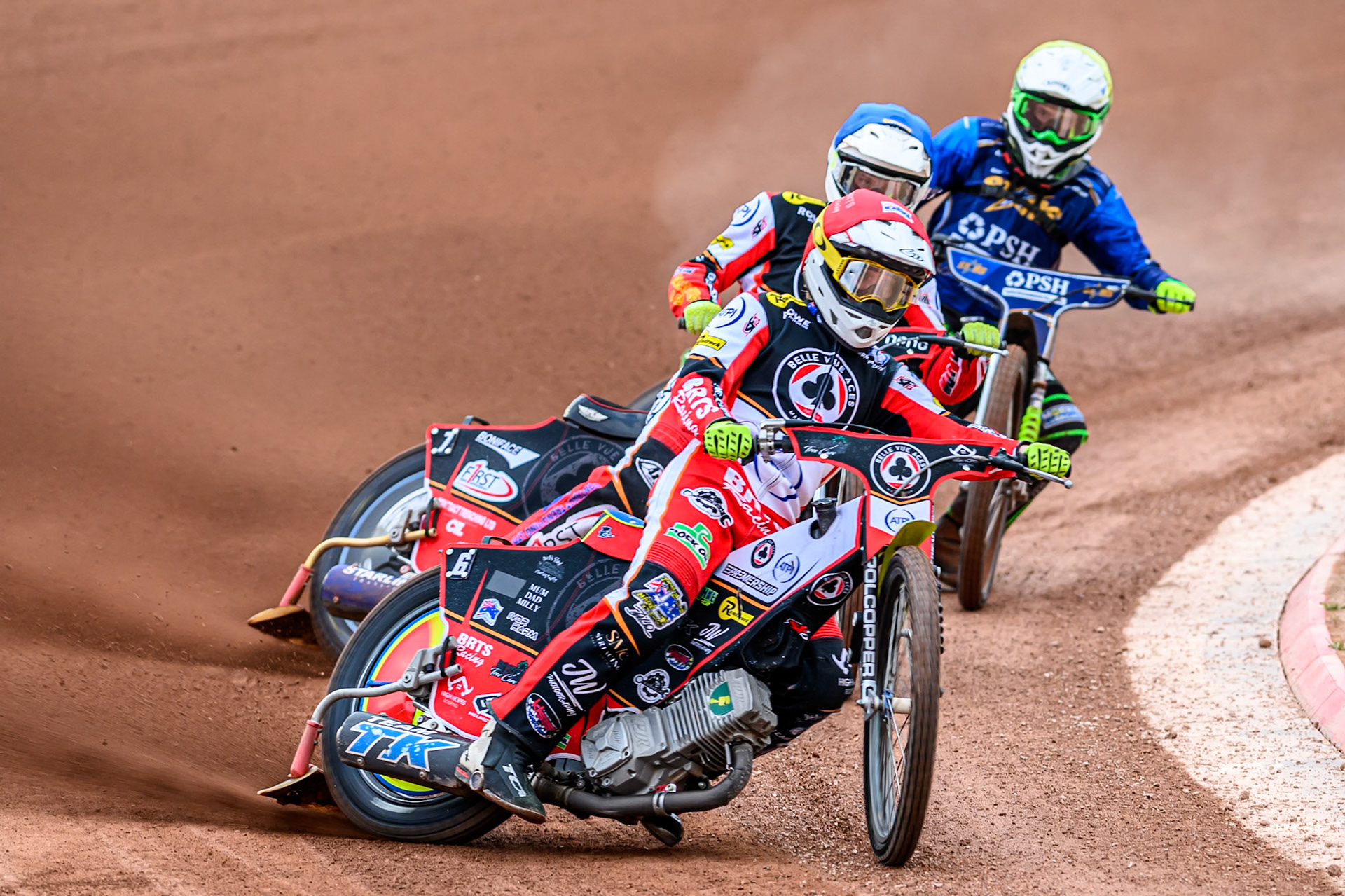 Belle Vue Aces' Tate Zischke in Red leading Belle Vue Aces' Jake Mulford in Blue and Kings Lynn Stars' Luke Harrison in Yellow during the Rowe Motor Oil Premiership match between Belle Vue Aces and King's Lynn Stars at the National Speedway Stadium, Manchester on Monday 23rd June 2025. (Photo: Ian Charles | MI News)