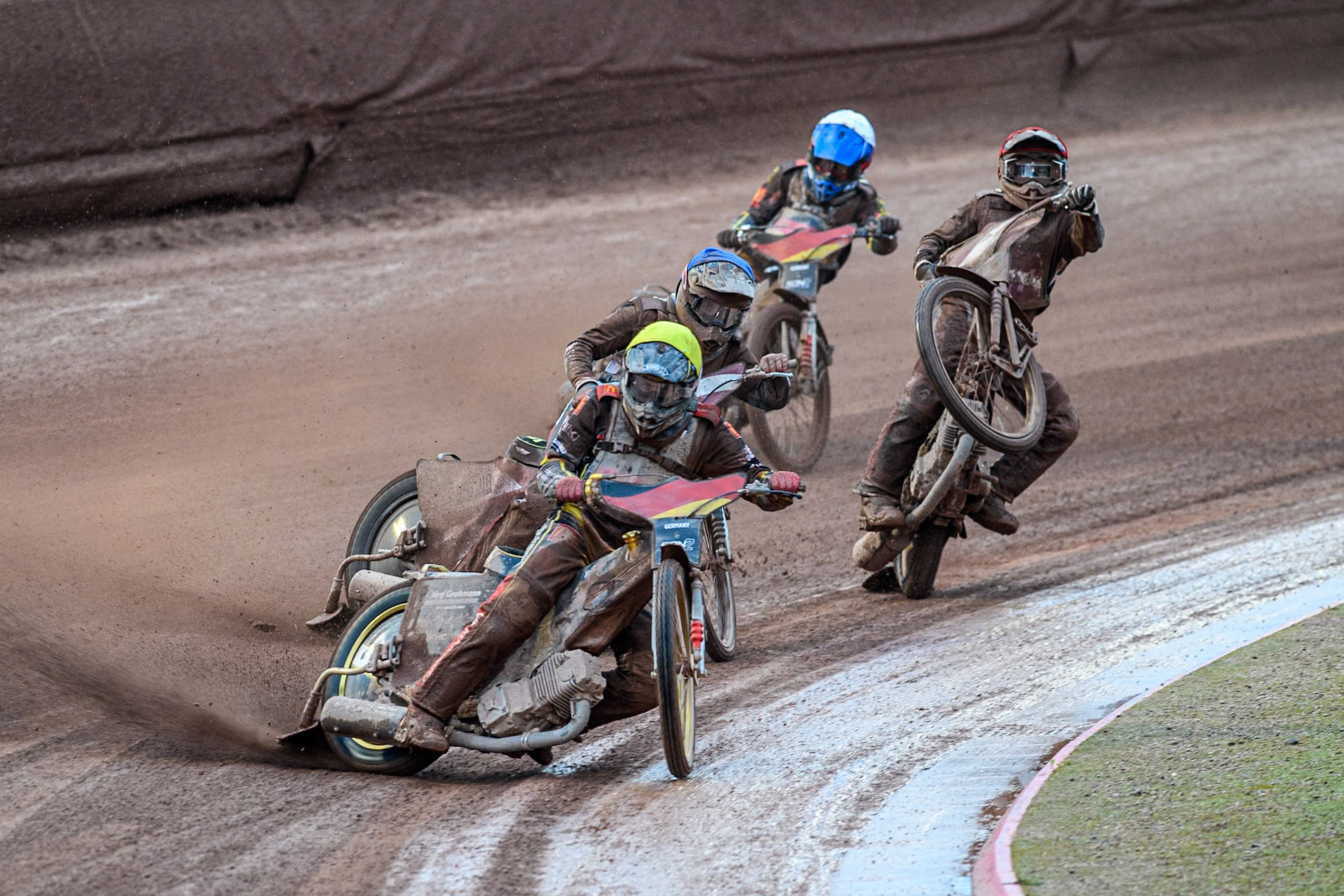 Norick Blödorn of Germany in Yellow leading Nikita Kaulins of Latvia in Blue as Artjoms Juhno of Latvia in Red picks up some drive ahead of Patrick Hyjek of Germany in White during the Monster Energy FIM Speedway of Nations 2 (Under 21) Final at the National Speedway Stadium, Manchester on Friday 12th July 2024. (Photo: Ian Charles | MI News)