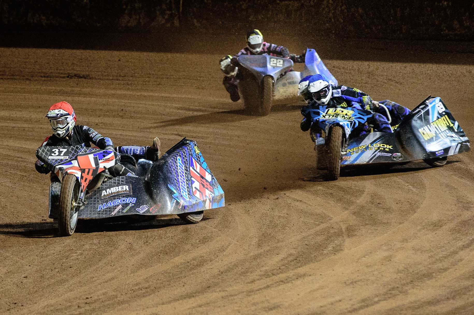 MANCHESTER, UK. OCT 30TH   Mark Cossar &amp; Gareth Williams  (Red) leads Matt Tyrell &amp; Liam Brown  (Blue) and Will Penfold &amp; Ricky Pay  (Yellow) in the Sidecar Final during the Manchester Masters Sidecar Speedway and Flat Track Racing at the National Speedway Stadium, Manchester on Saturday 30th October 2021. (Credit: Ian Charles | MI News)
