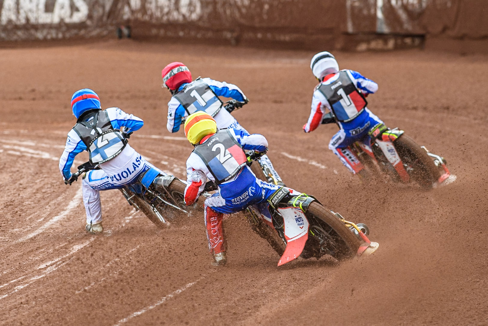 Steven Goret of France in Yellow chases Antti Vuolas of Finland in Blue, Jesse Mustonen of Finland in Red and David Bellego of France in White during the Monster Energy FIM Speedway of Nations Semi-Final 1 at the National Speedway Stadium, Manchester on Tuesday 9th July 2024. (Photo: Ian Charles | MI News)