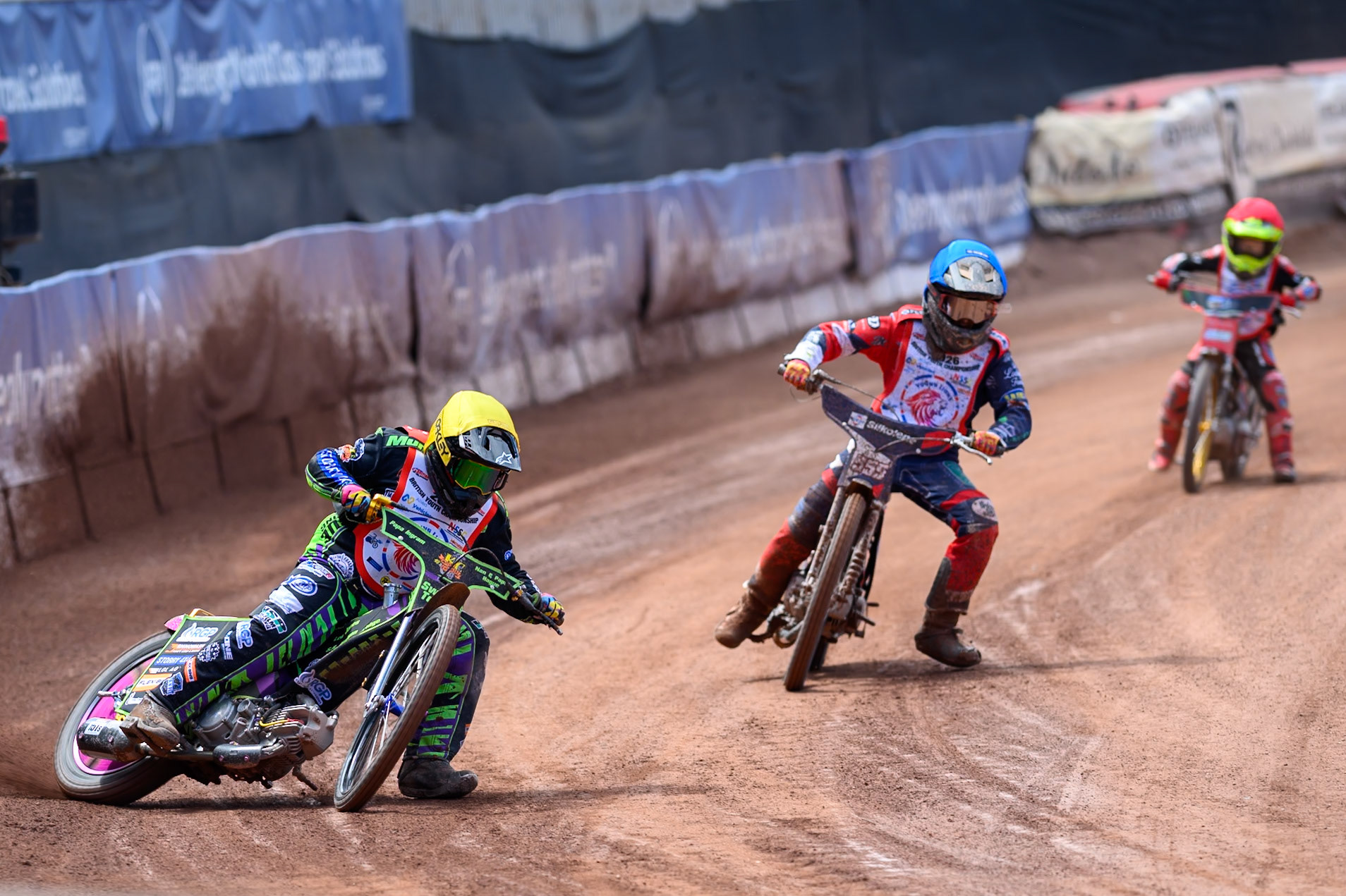 BRITISH YOUTH CHAMPIONSHIP 125cc Lewis Hague (322) in Yellow leading Fraser Buckle (555) in Blue and Oscar Berwick (68) in Red during the British Youth Championship (125cc) at the National Speedway Stadium, Manchester on Sunday 19th July 2026. (Photo: Ian Charles | MI News)