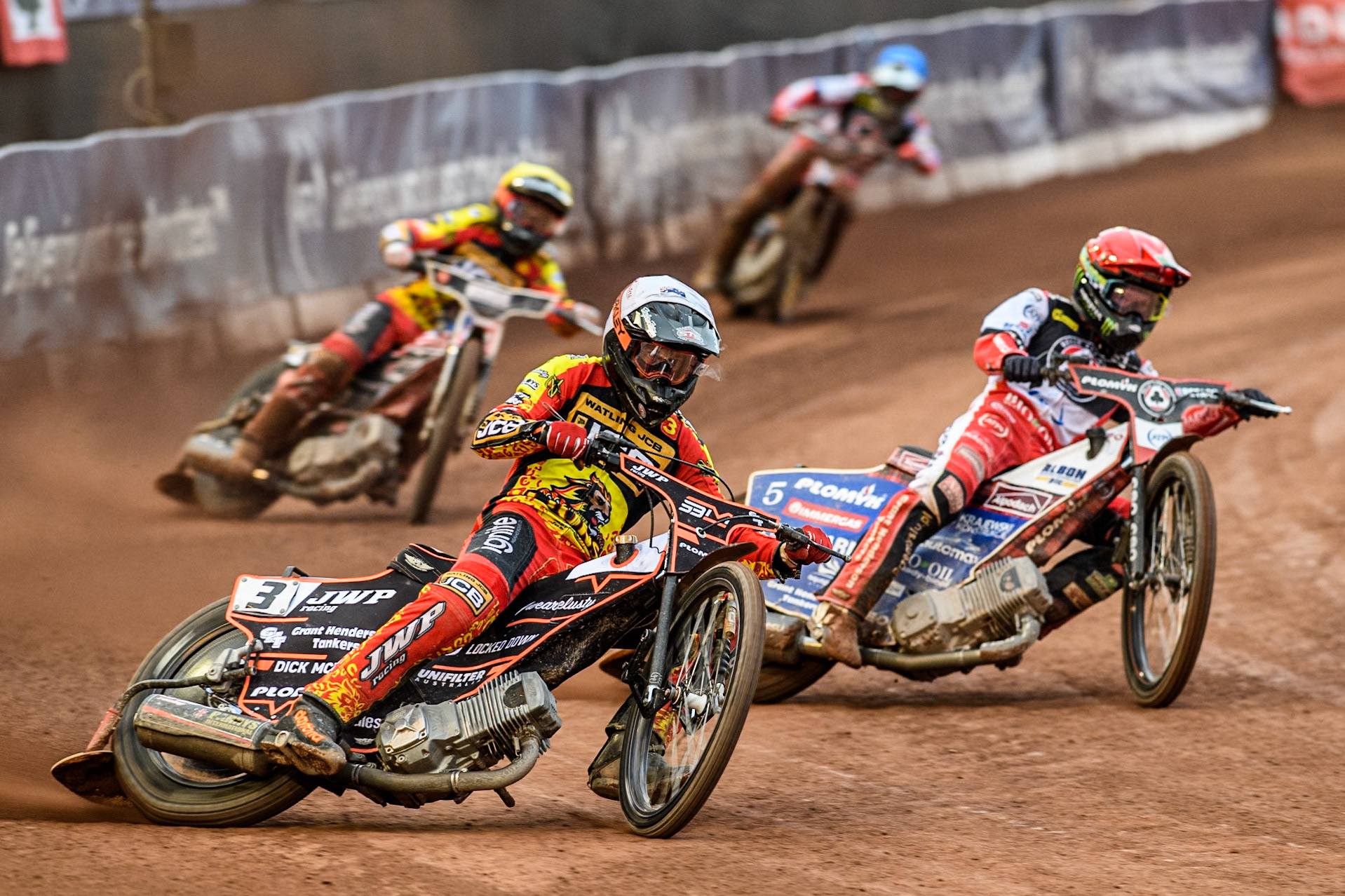Leicester Lions' Sam Masters in White rides outside Belle Vue Aces' Dan Bewley in Red with Leicester Lions' Luke Becker in Yellow and Belle Vue Aces' Connor Mountain in Blue behind during the Rowe Motor Oil Premiership match between Belle Vue Aces and Leicester Lions at the National Speedway Stadium, Manchester on Monday 24th June 2024. (Photo: Ian Charles | MI News)