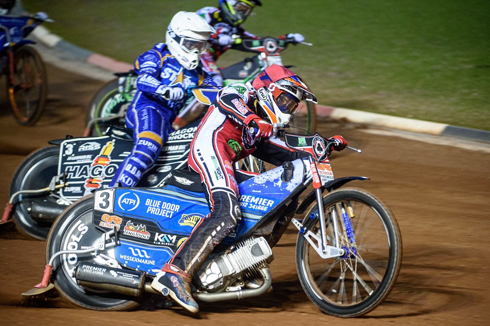 MANCHESTER, UK. SEPT 13TH  Steve Worrall  (Red) passes Erik Riss  (White) with Charles Wright  (Blue) on the inside during the SGB Premiership match between Belle Vue Aces and King's Lynn Stars at the National Speedway Stadium, Manchester on Monday 13th September 2021. (Credit: Ian Charles | MI News)