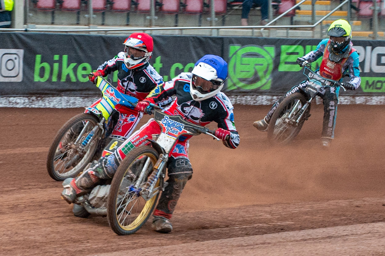MANCHESTER, UK. JULY 2ND  Paul Bowen  (Blue) and Benji Compton  (Red) make the start over Josh Warren  (Yellow) during the National Development League match between Belle Vue Colts and Kent Royals at the National Speedway Stadium, Manchester on Friday 2nd July 2021. (Credit: Ian Charles | MI News)