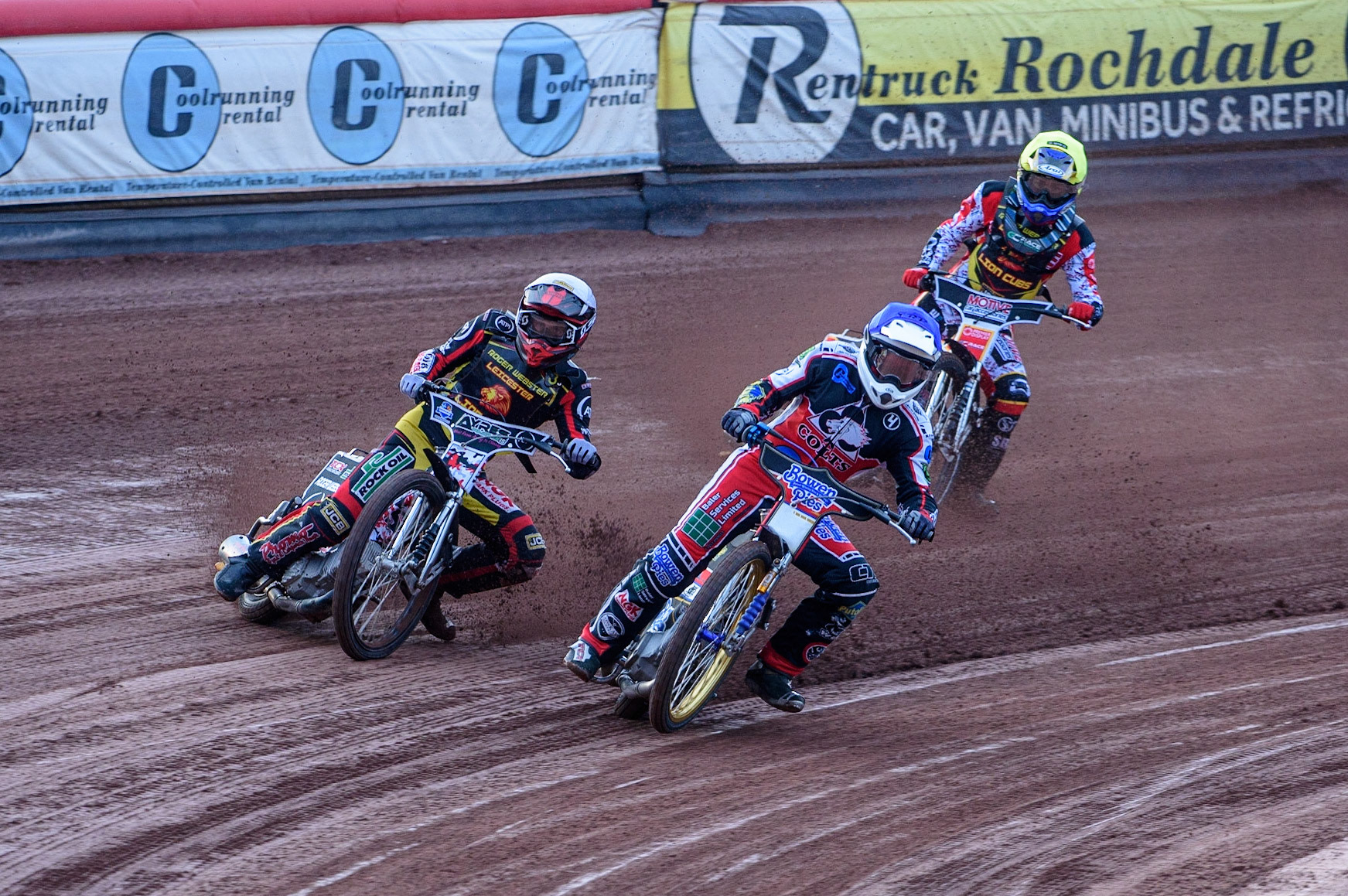 MANCHESTER, UK. JULY 29TH  Paul Bowen  (Blue) picks up some drive causing him to fall as he leads Joe Lawlor  (White) and Tom Spencer   (Yellow)  during the National Development League match between Belle Vue Colts and Leicester Lion Cubs at the National Speedway Stadium, Manchester on Thursday 29th July 2021. (Credit: Ian Charles | MI News)
