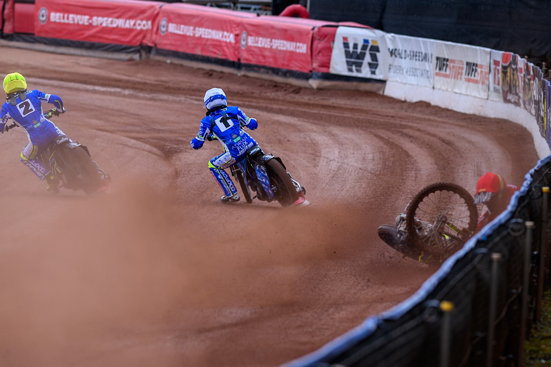Belle Vue Colts' William Cairns falls whilst trying to pass Oxford Chargers' Jody Scott  in White and Oxford Chargers' Jacob Clouting  in Yellow during the WSRA National Development League match between Belle Vue Colts and Oxford Chargers at the National Speedway Stadium, Manchester on Sunday 1st June 2025. (Photo: Ian Charles | MI News)