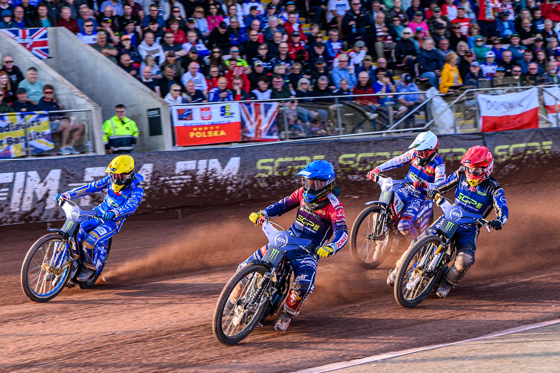 Dominik Kubera (415) of Poland in Blue rides inside Bartosz Zmarzlik (95) of Poland in Yellow with Robert Lambert (505) of Great Britain in Red and Dan Bewley (99) of Great Britain in White behind during the ATPI FIM Speedway Grand Prix Round 5 at the National Speedway Stadium, Manchester, on Saturday 14th June 2025. (Photo: Ian Charles | MI News)