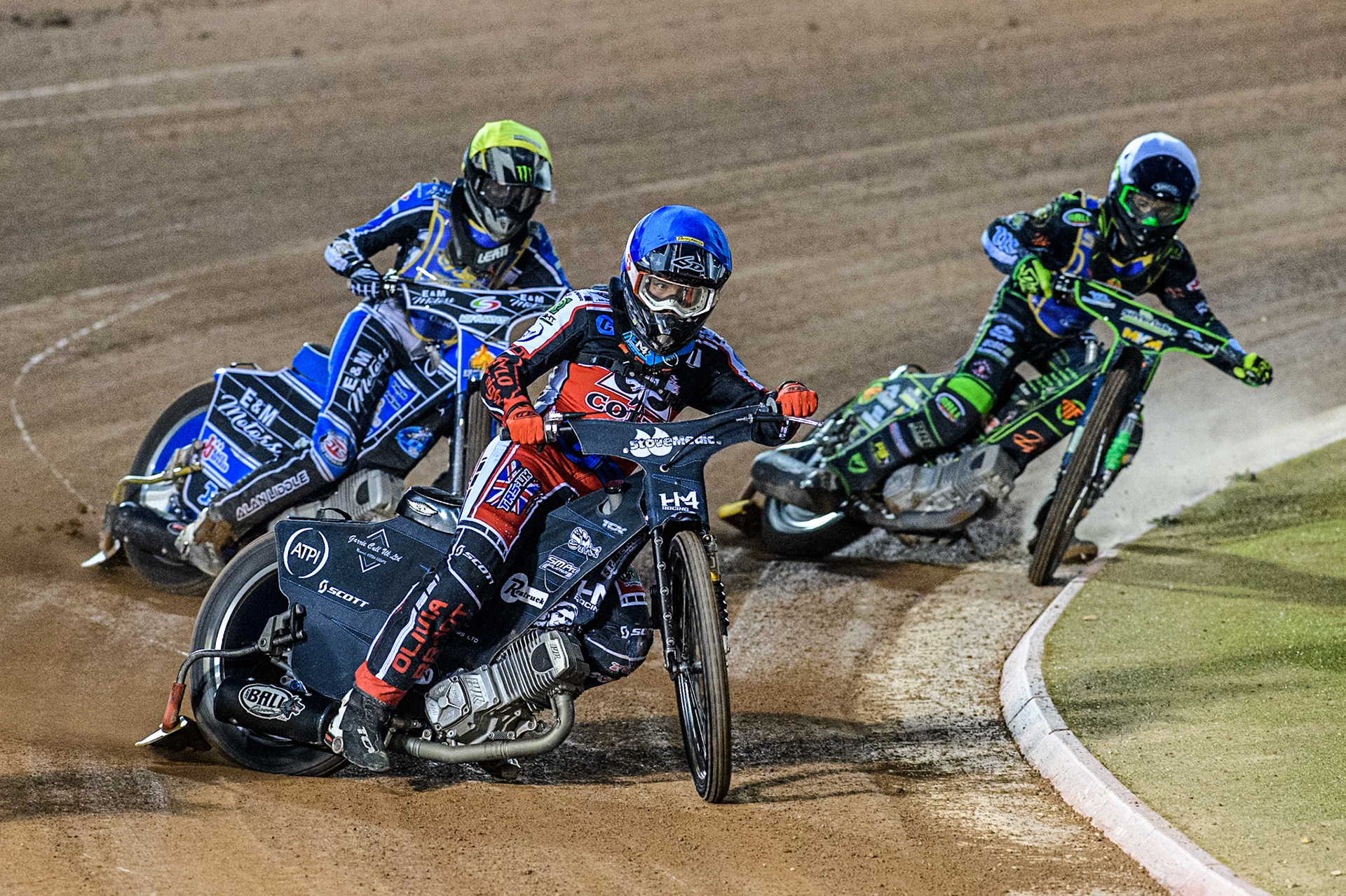Belle Vue Colts' Harry McGurk in Blue leading Edinburgh Monarchs' Guest Rider Lee Harrison in Yellow and Edinburgh Monarchs' Max Perry in White during the WSRA National Development League match between Belle Vue Aces and Edinburgh Monarchs at the National Speedway Stadium, Manchester on Friday 30th August 2024. (Photo: Ian Charles | MI News)