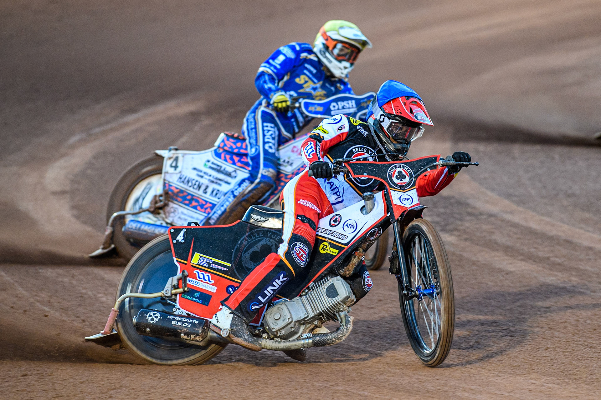 Zach Cook of Belle Vue Aces in Blue leading Niels-Kristian Iversen of Kings Lynn Stars in Yellow during the Rowe Motor Oil Premiership match between Belle Vue Aces and King's Lynn Stars at the National Speedway Stadium, Manchester on Monday 5th April 2025. (Photo: Ian Charles | MI News)
