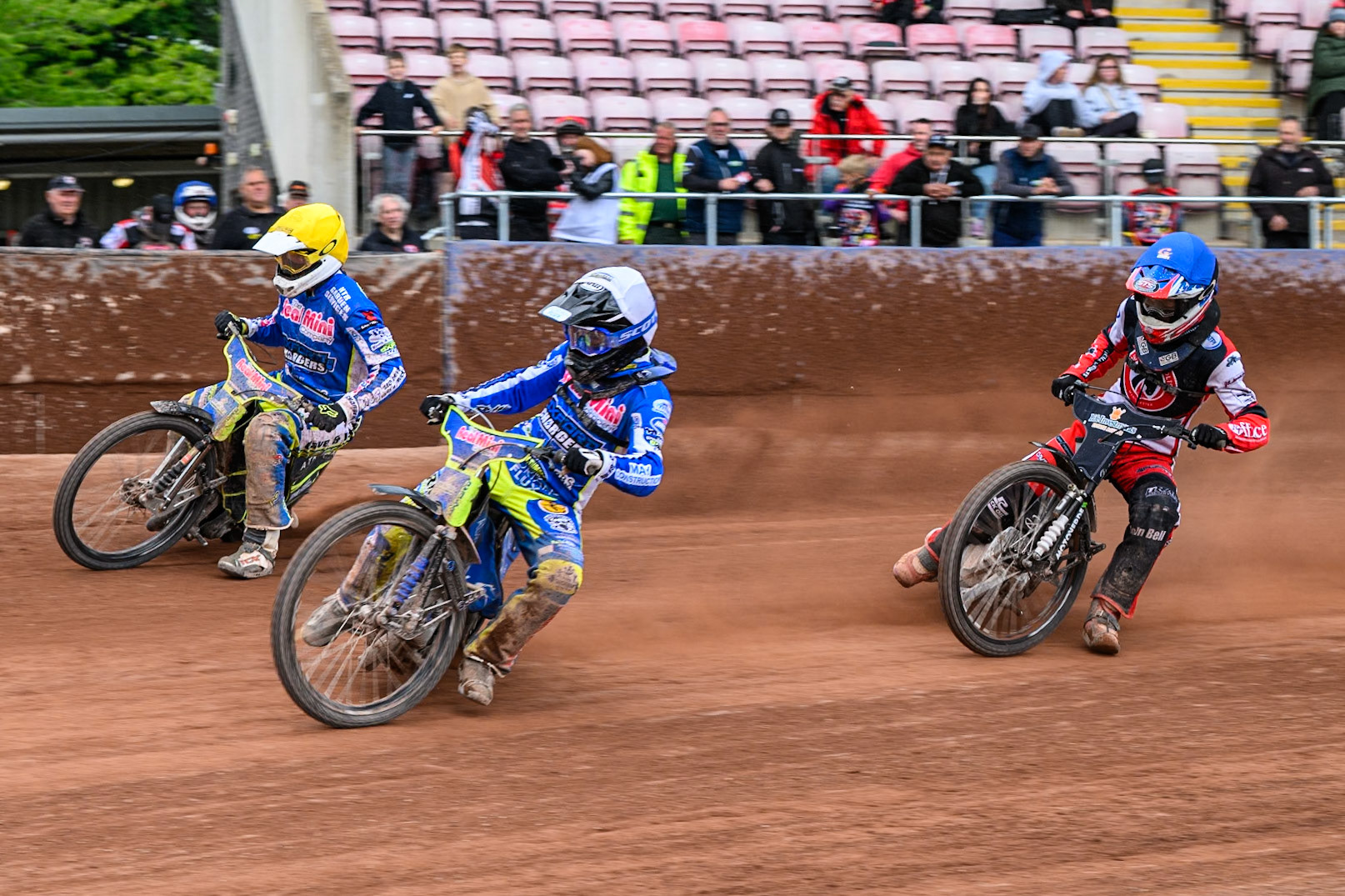 Oxford Chargers' Jody Scott  in White rides inside Oxford Chargers' Darryl Ritchings  in Yellow with Belle Vue Colts' Freddy Hodder  in Blue behind during the WSRA National Development League match between Belle Vue Colts and Oxford Chargers at the National Speedway Stadium, Manchester on Sunday 1st June 2025. (Photo: Ian Charles | MI News)