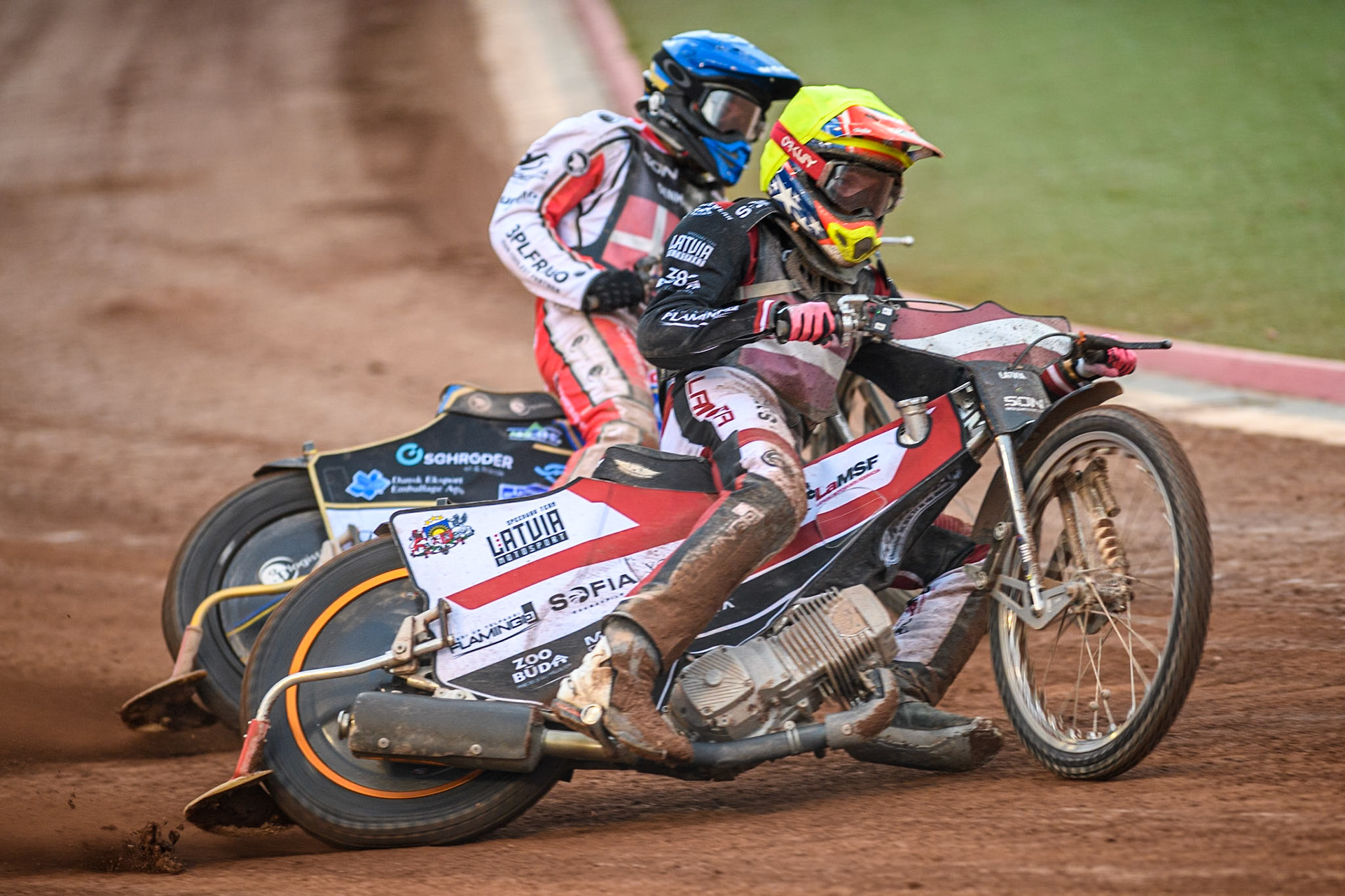 Daniils Kolodinskis of Latvia in Yellow leading Rasmus Jensen of Denmark in Blue during the Monster Energy FIM Speedway of Nation Final at the National Speedway Stadium, Manchester on Saturday 13th July 2024. (Photo: Ian Charles | MI News)