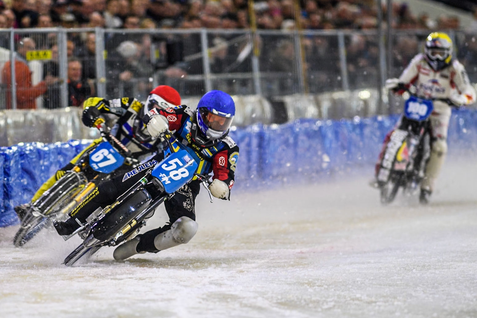 Sweden's Stefan Svensson (58) in Blue leading Finland's Heikki Huusko (67) in Red during the FIM Ice Speedway Gladiators World Championship Final 4 at Ice Rink Thialf, Heerenveen on Sunday 7th April 2024. (Photo: Ian Charles | MI News)