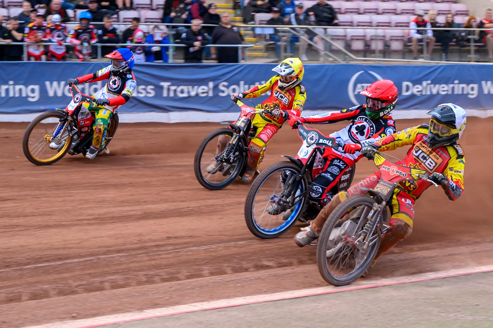 Ryan Douglas of Leicester Lions in White rides inside Brady Kurtz of Belle Vue Aces in Red, Sam Masters of Leicester Lions in Yellow and Jason Doyle of Belle Vue Aces in Blue during the Rowe Motor Oil Premiership match between Belle Vue Aces and Leicester Lions at the National Speedway Stadium, Manchester on Monday 15th June 2026. (Photo: Ian Charles | MI News)