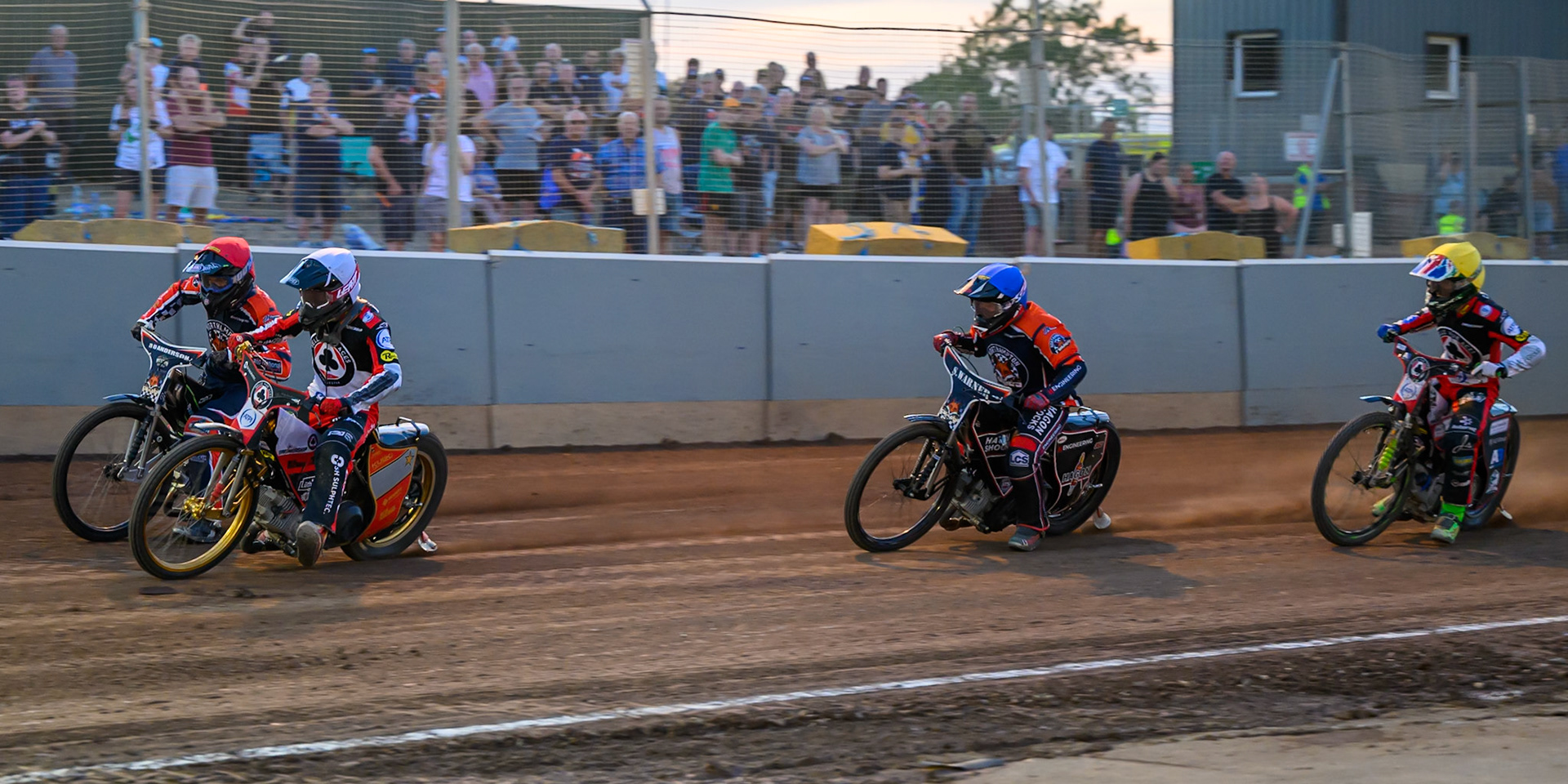 Norick Blodorn of Belle Vue Aces  in White rides inside Kye Thomson of Northampton Foxes in Red  with Sam Hagon, Guest Rider for Northampton Foxes in Blue  and Will Cairns of Belle Vue Aces in Yellow  behind during the Rowe Motor Oil Premiership match between Northampton Foxes and Belle Vue Aces at Northampton International Shaleway, Northampton on Thursday 13th August 2026. (Photo: Ian Charles | MI News)