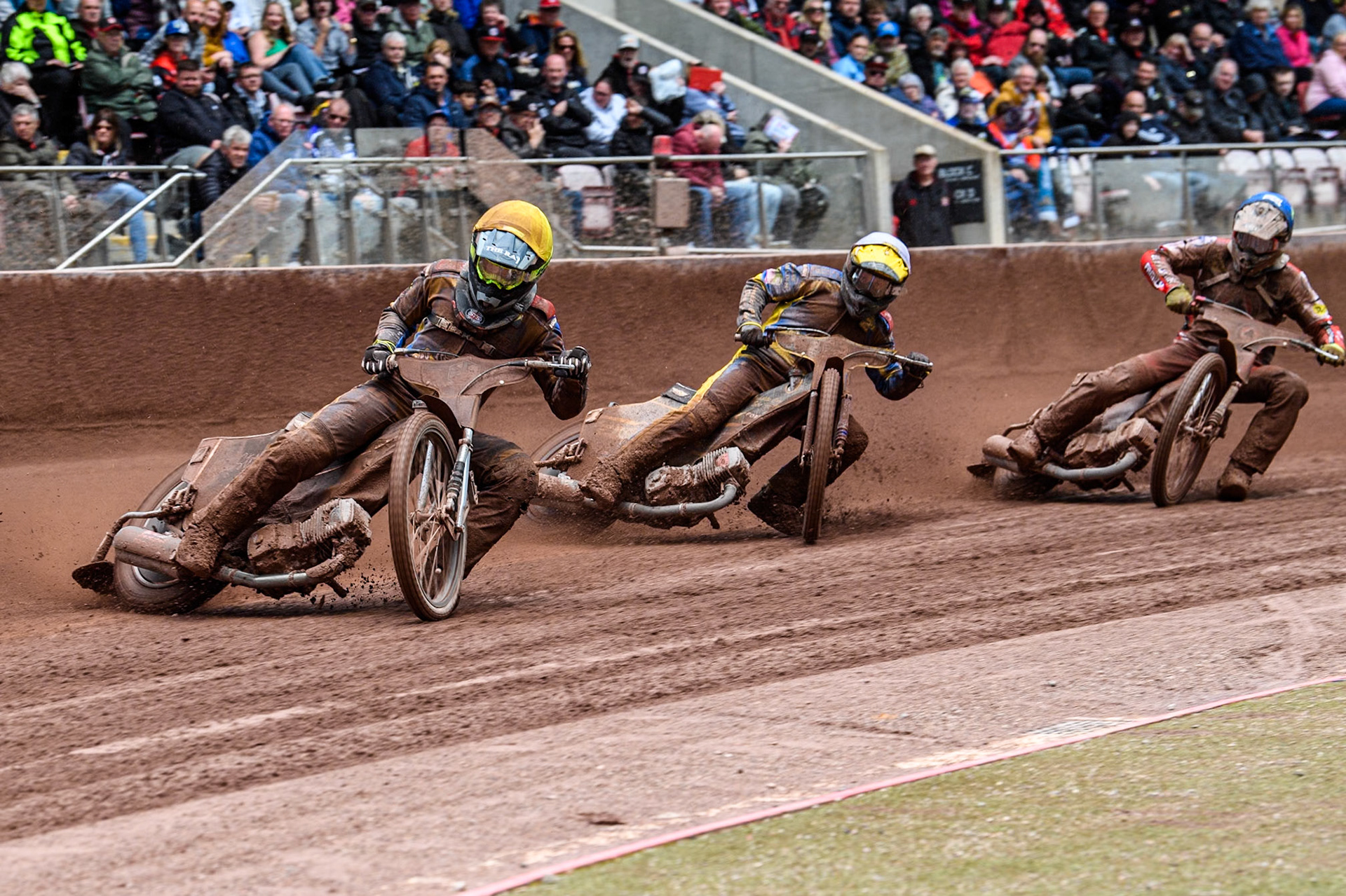 Sheffield Tigers' Dan Gilkes in Yellow leading Sheffield Tigers' Kyle Howarth in White and Belle Vue Aces' Connor Bailey in Blue during the Rowe Motor Oil Premiership match between Belle Vue Aces and Sheffield Tigers at the National Speedway Stadium, Manchester on Monday 27th May 2024. (Photo: Ian Charles | MI News)