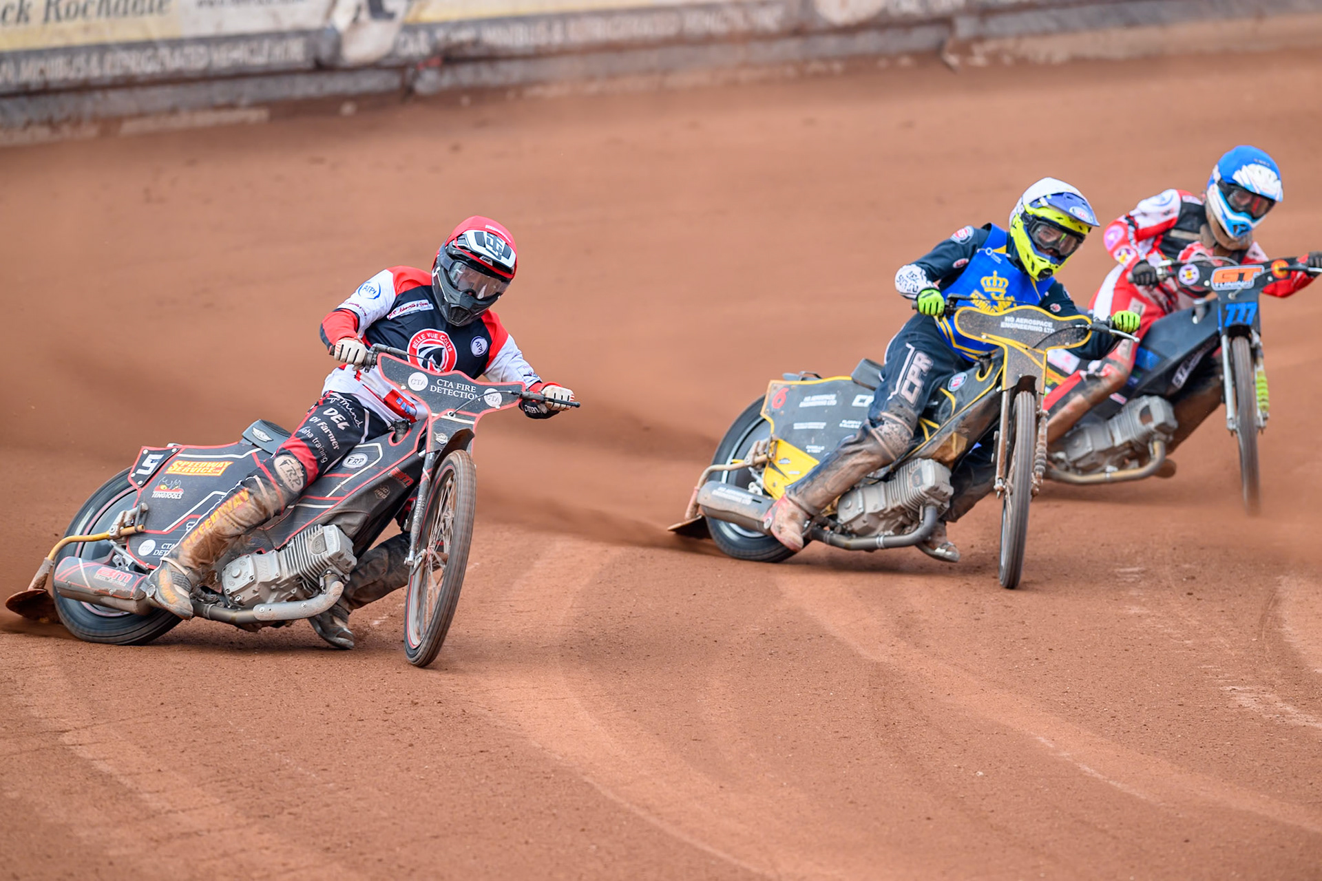 Belle Vue Colts' Guest Rider Ben Morley in Red rides outside Monarchs' Guest Rider Vinnie Foord in White and Belle Vue Colts' Billy Budd. in Blue during the WSRA National Development League match between Belle Vue Aces and Edinburgh Academy at the National Speedway Stadium, Manchester on Sunday 12th October 2025. (Photo: Ian Charles | MI News)