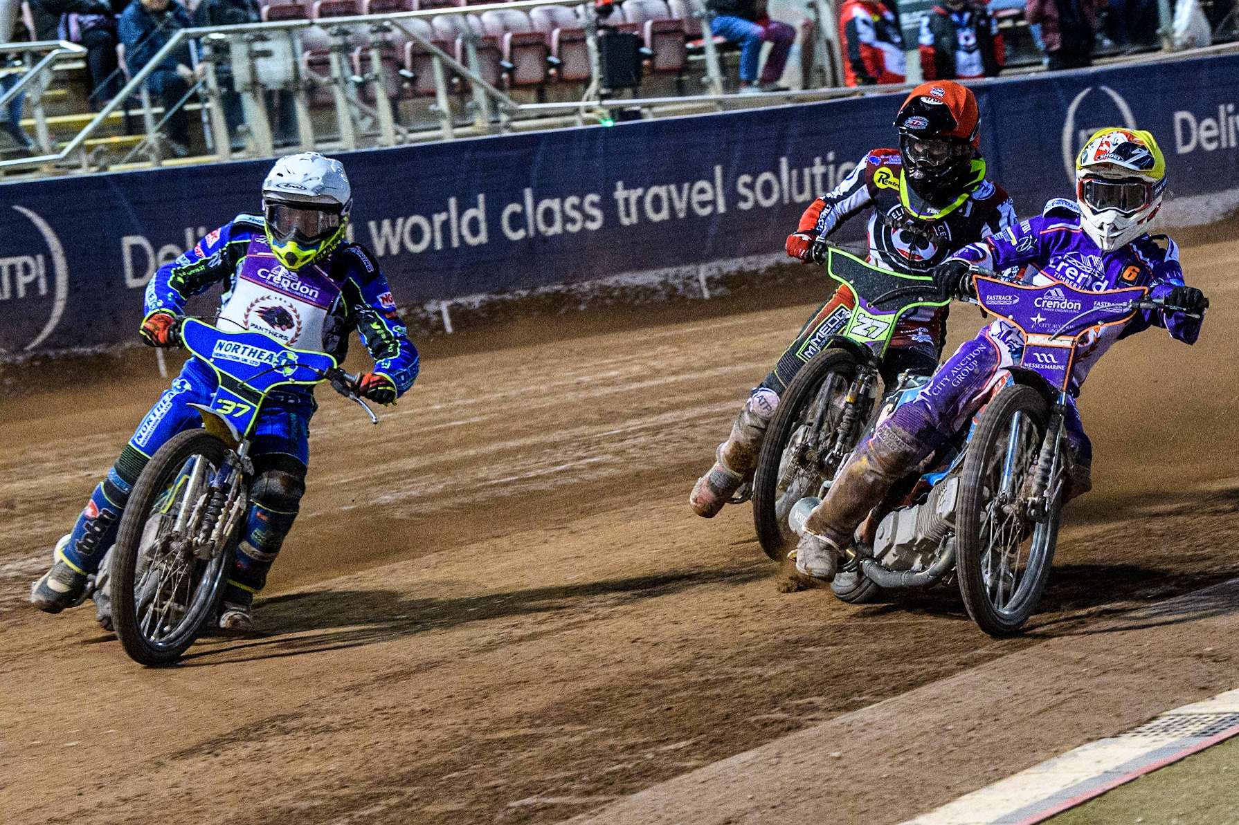 Chris Harris   (White) and Ben Cook  (Yellow) try to hold out Tom Brennan  (Red) during the SGB Premiership match between Belle Vue Aces and Peterborough at the National Speedway Stadium, Manchester on Monday 24th April 2023. (Photo: Ian Charles | MI News)