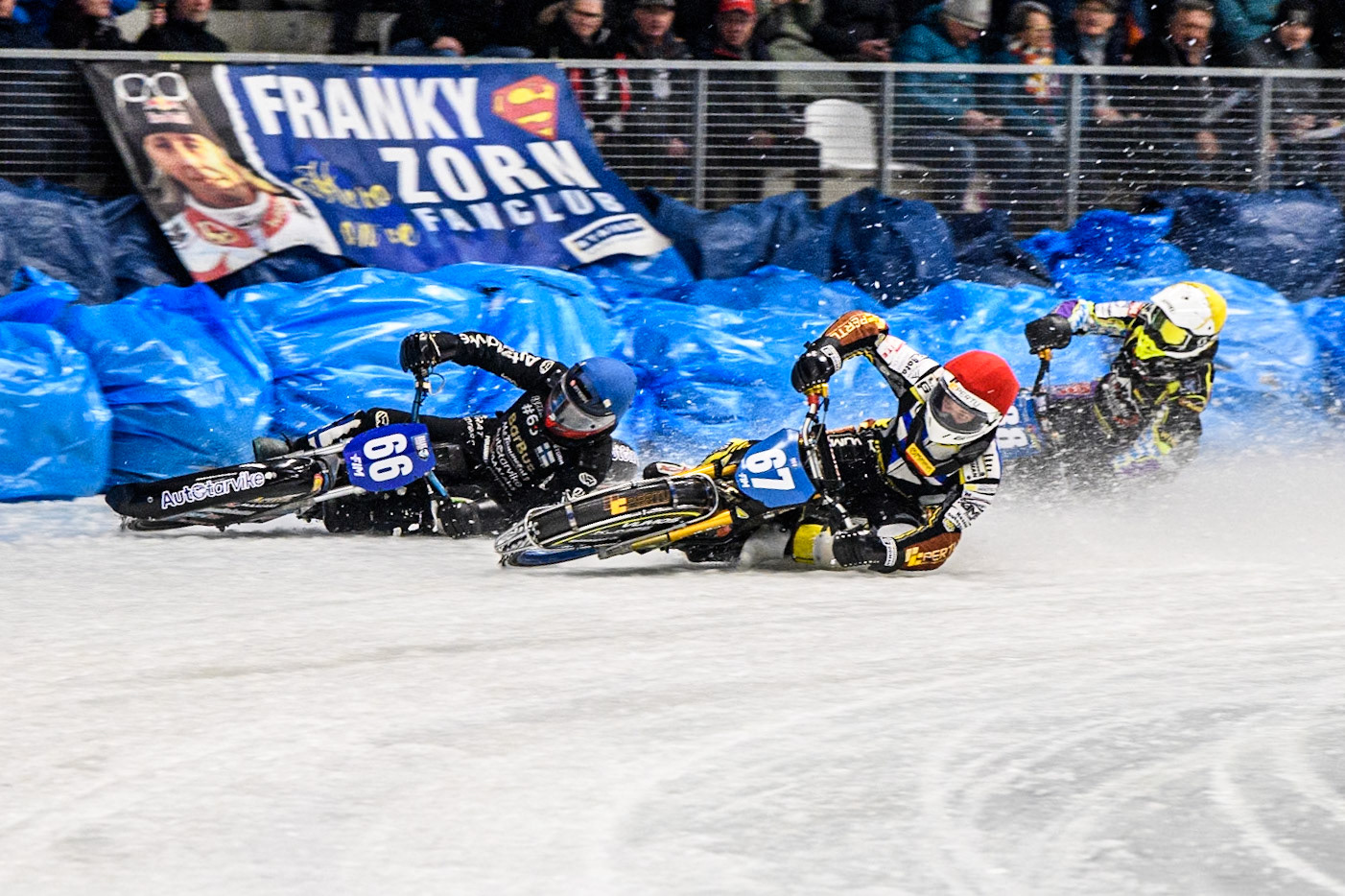 Heikki Huusko (67) of Finland in Red rides inside Aki Ala-Riihimäki (66) of Finland in Blue with Max Niedermaier  (88) of Germany in White behind during the Ice Speedway Gladiators World Championship Final 2 at Max-Aicher-Arena, Inzell on Sunday 16th March 2025. (Photo: Ian Charles | MI News)