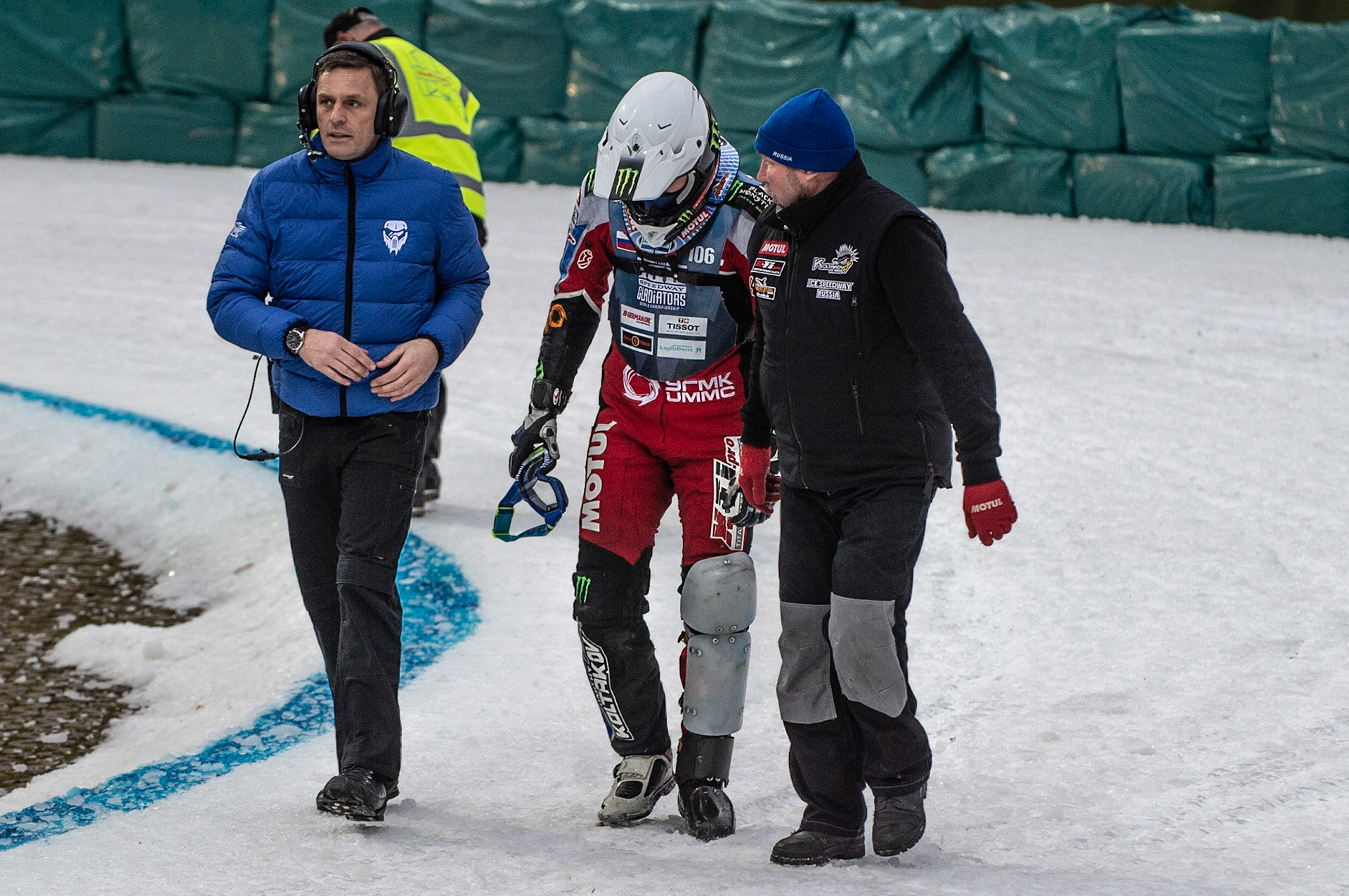 Photo: Ian Charles

Dmitri Koltakov (106) walks back to the pits after his heat 4 fall flanked with race director Phil Morris (left) and his father (right)

FIM Ice Speedway Gladiators World Championship, Final 3.1, Horst-Dohm Eisstadion, Berlin, Germany Saturday  2  March  2019