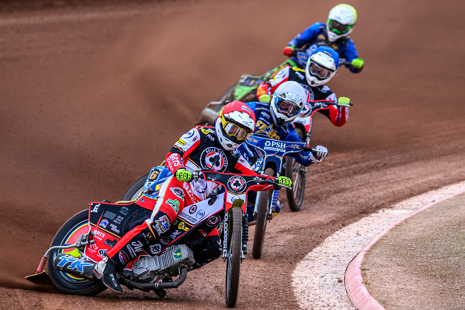 Belle Vue Aces' Tate Zischke in Red leading Kings Lynn Stars' Guest Rider, Anders Rowe in White, Belle Vue Aces' Jake Mulford in Blue and Kings Lynn Stars' Luke Harrison in Yellow during the Rowe Motor Oil Premiership match between Belle Vue Aces and King's Lynn Stars at the National Speedway Stadium, Manchester on Monday 23rd June 2025. (Photo: Ian Charles | MI News)