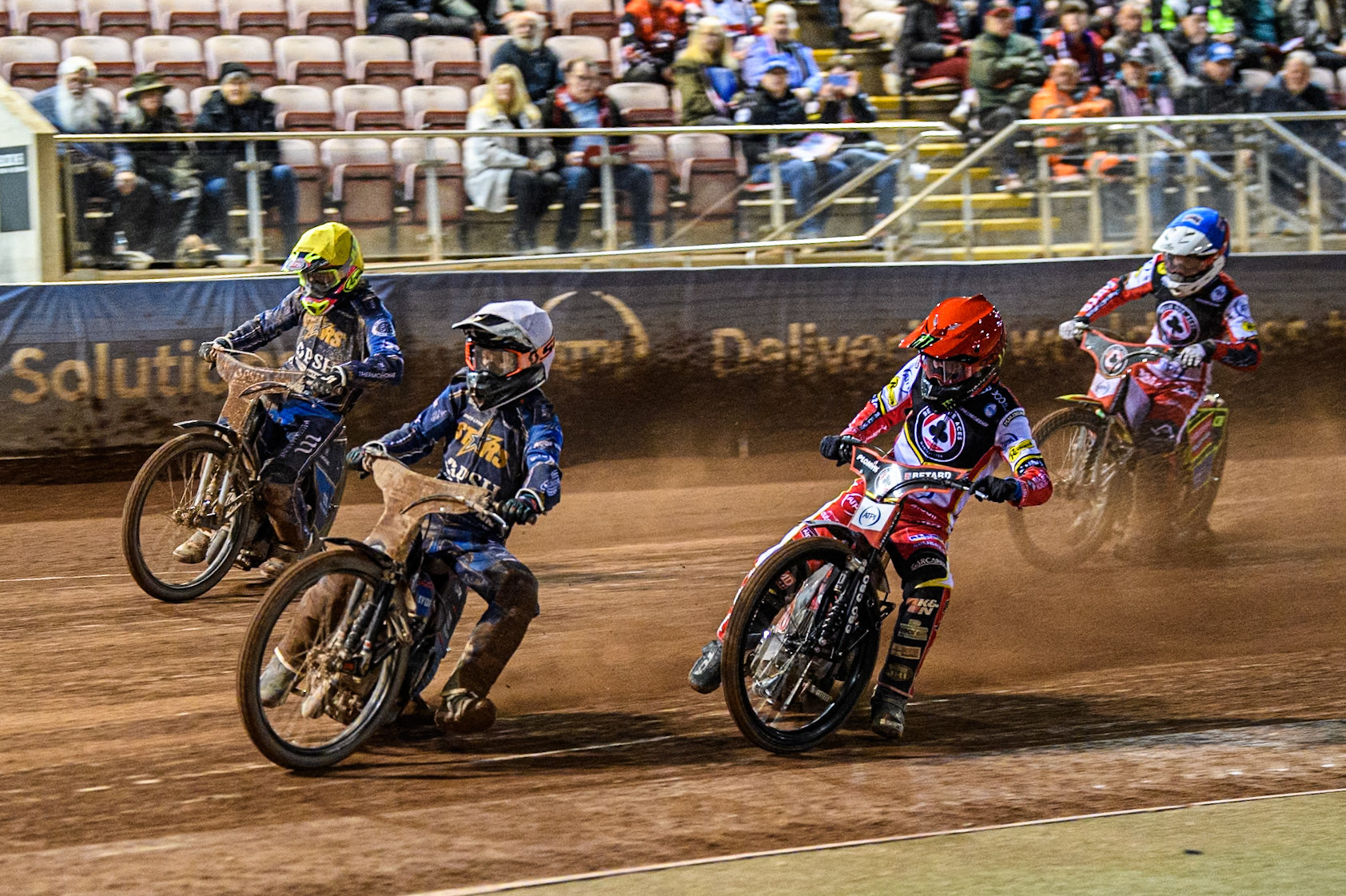 Ben Cook of Kings Lynn Stars in White leading Dan Bewley of Belle Vue Aces in Red Richard Lawson of Kings Lynn Stars in Yellow and Tate Zischke of Belle Vue Aces in Blue during the Rowe Motor Oil Premiership match between Belle Vue Aces and King's Lynn Stars at the National Speedway Stadium, Manchester on Monday 5th April 2025. (Photo: Ian Charles | MI News)