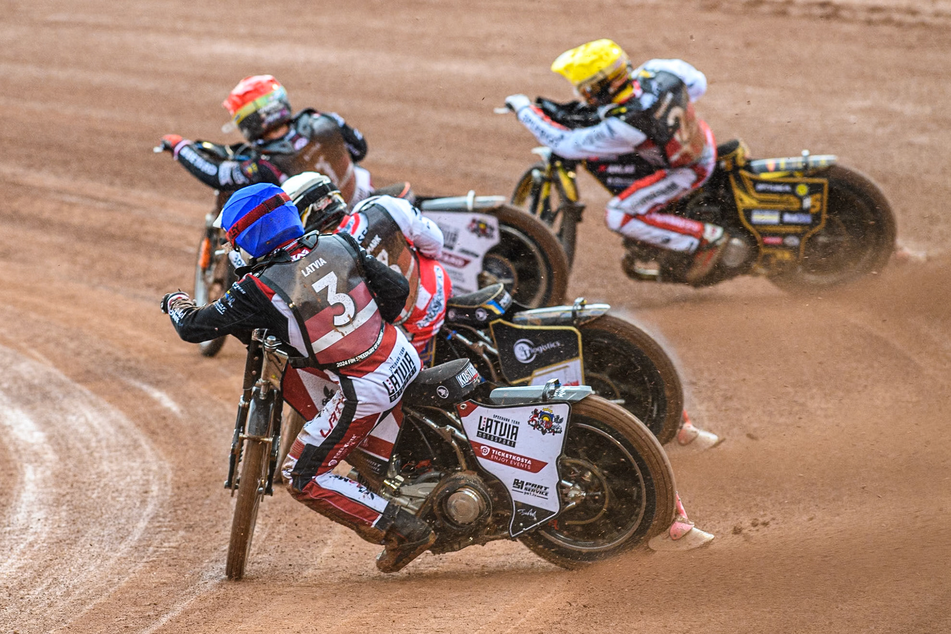 Francis Gusts of Latvia in Blue chases Rasmus Jensen of Denmark in White, Anders Thomsen of Denmark in Yellow and Andzejs Lebedevs of Latvia in Red during the Monster Energy FIM Speedway of Nation Semi Final 2 at the National Speedway Stadium, Manchester on Wednesday 10th July 2024. (Photo: Ian Charles | MI News)