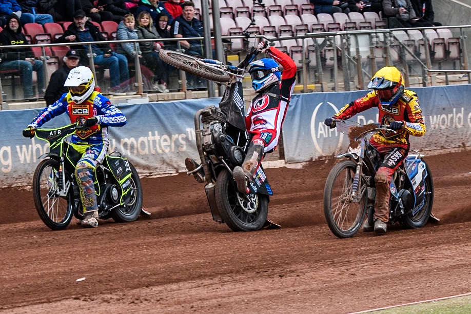 Belle Vue Colts' Billy Budd rears at the start between Leicester Lion Cubs' Guest Rider Darryl Ritchings in White and Leicester Lion Cubs' Sonny Springer in Yellow during the WSRA National Development League match between Belle Vue Colts and Leicester Lion Cubs at the National Speedway Stadium, Manchester on Friday 18th April 2025. (Photo: Ian Charles | MI News)