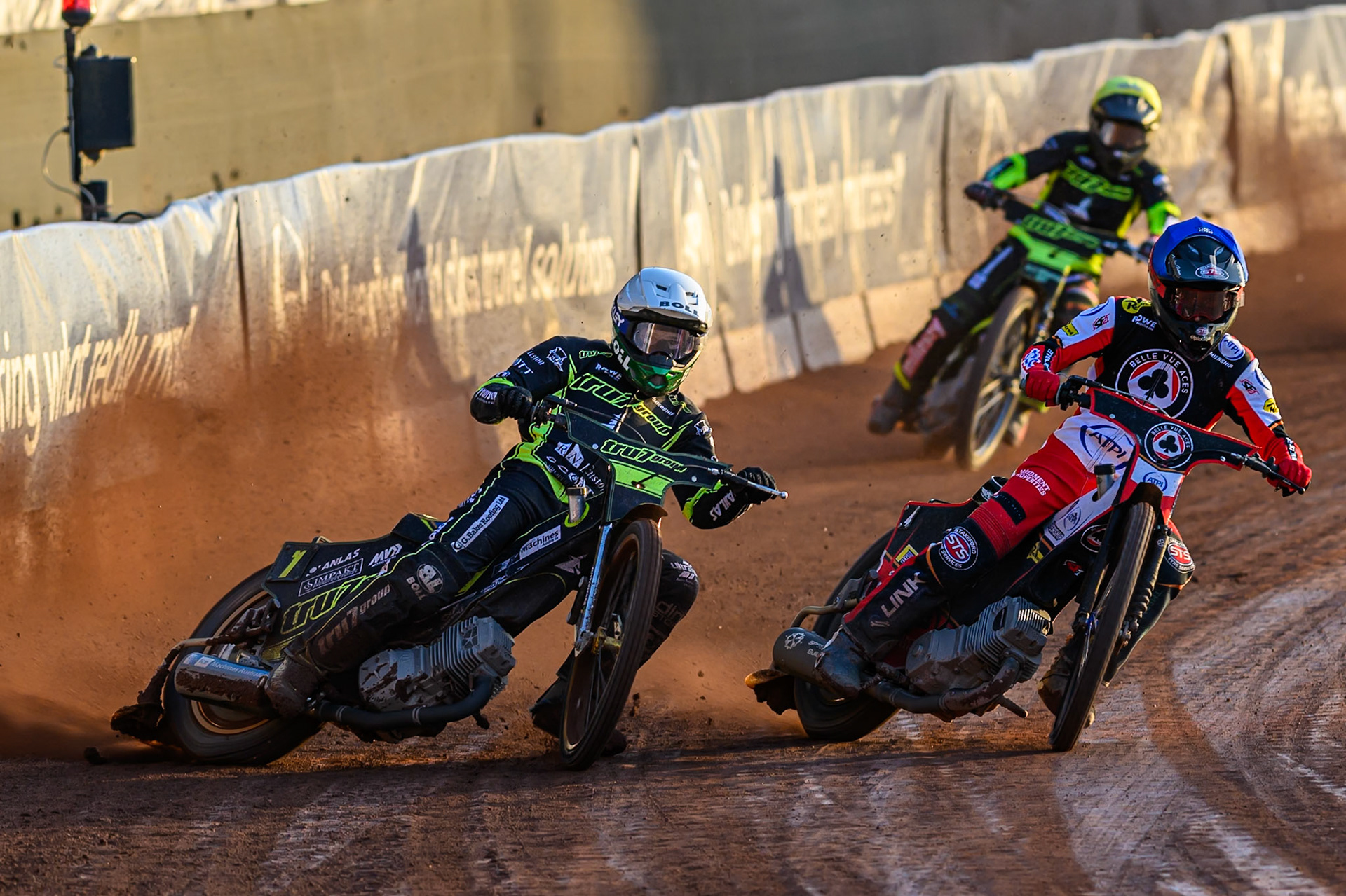 Jason Doyle of Ipswich Witches in White rides outside Zach Cook of Belle Vue Aces in Blue with Danny King of Ipswich Witches  in Yellow behind  during the Rowe Motor Oil Premiership match between Belle Vue Aces and Ipswich Witches at the National Speedway Stadium, Manchester on Monday 4th August 2025. (Photo: Ian Charles | MI News)