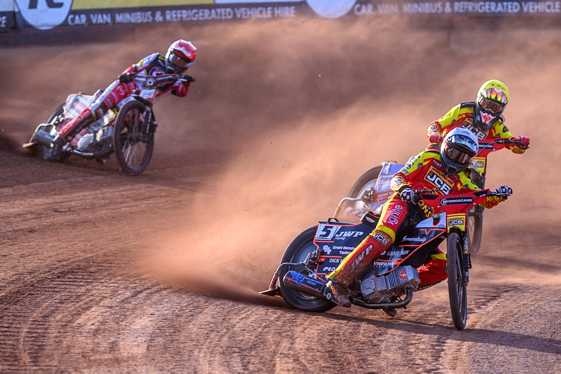 Leicester Lions' Sam Masters  in White leading Leicester Lions' Drew Kemp  in Yellow and Belle Vue Aces' Dan Bewley in Red during the Rowe Motor Oil Premiership match between Belle Vue Aces and Leicester Lions at the National Speedway Stadium, Manchester on Monday 14th July 2025. (Photo: Ian Charles | MI News)