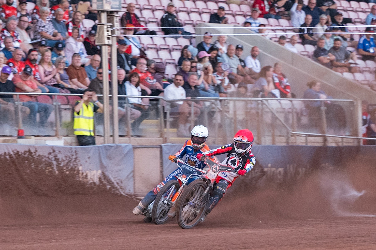 Zach Cook of Belle Vue Aces  in Red passes Nicolai Klindt of Northampton Foxes in White during the Rowe Motor Oil Premiership match between Belle Vue Aces and Northampton Foxes at the National Speedway Stadium, Manchester on Monday 13th July 2026. (Photo: Ian Charles | MI News)