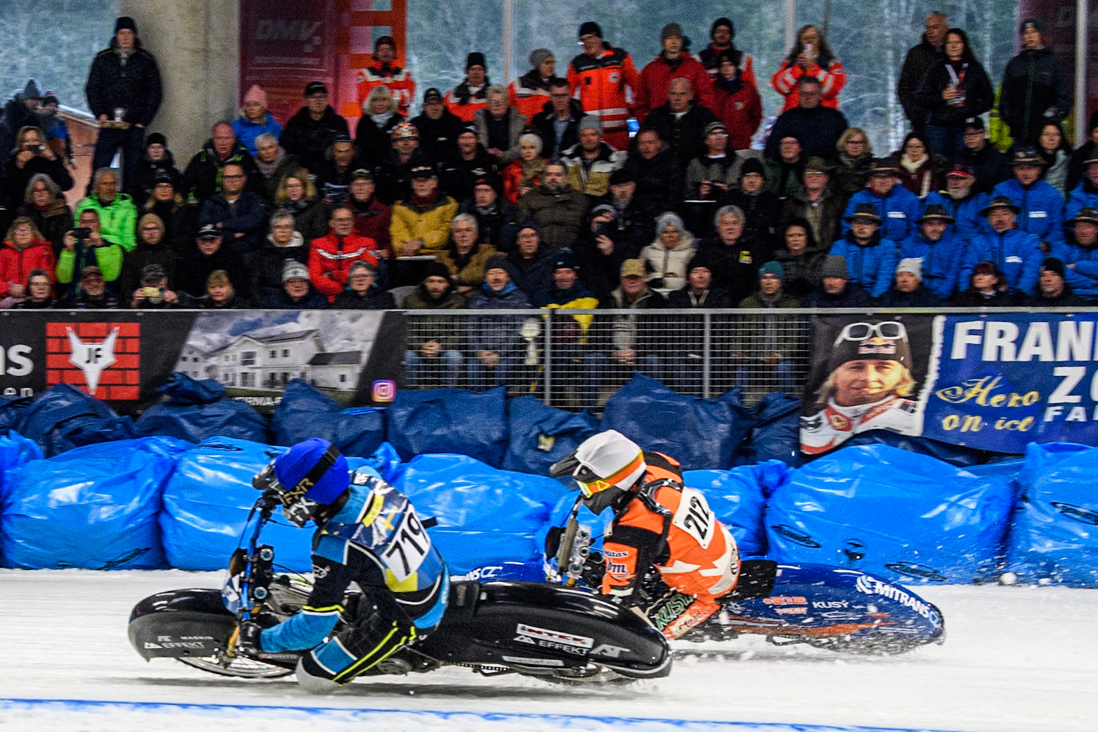 Filip Jäger (719) of Sweden in Blue rides inside Lukas Hutla (212) of the Czech Republic in White during the Ice Speedway Gladiators World Championship Final 2 at Max-Aicher-Arena, Inzell on Sunday 16th March 2025. (Photo: Ian Charles | MI News)
