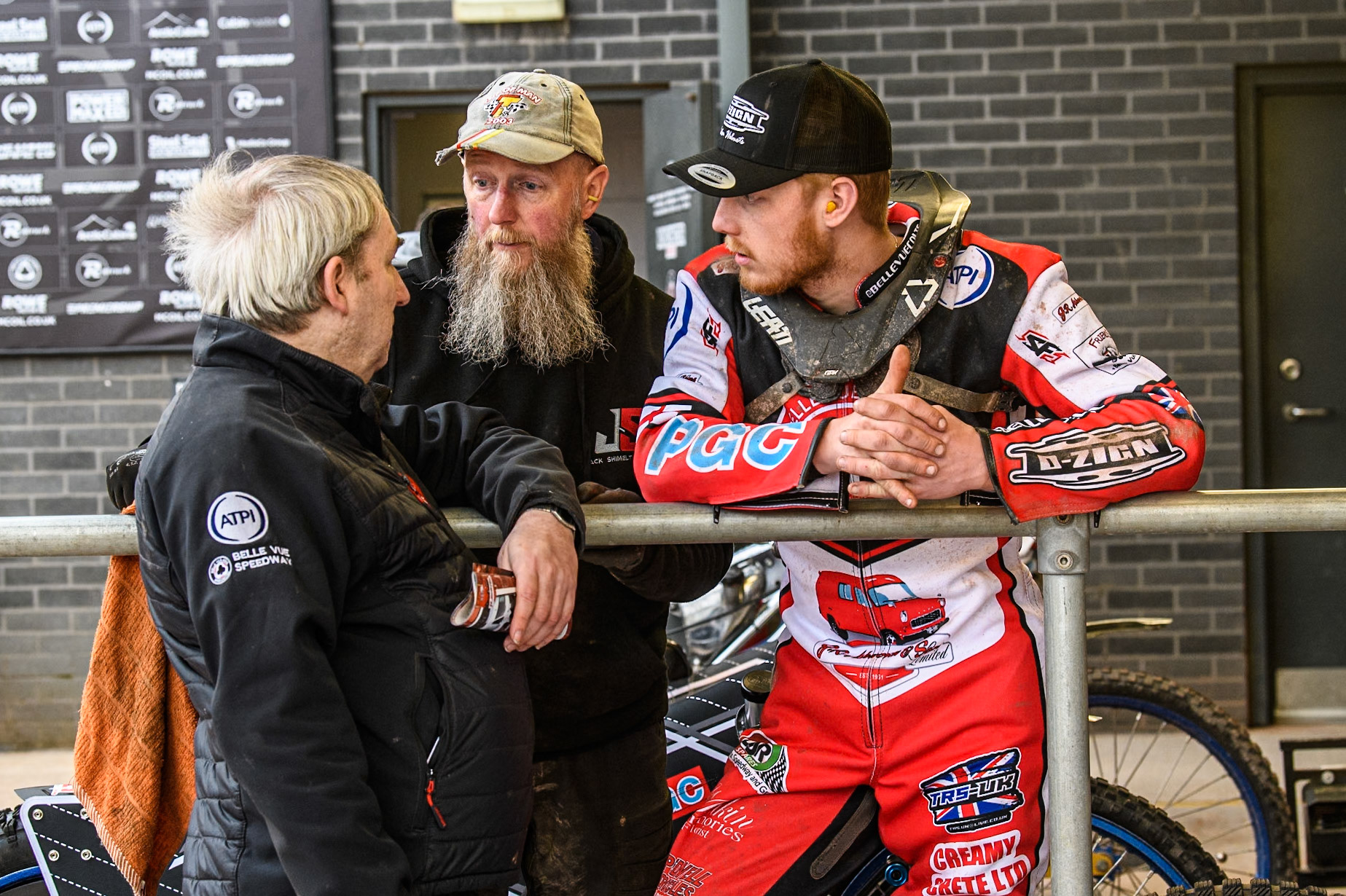 Belle Vue Colts' Joint Team Manager Graham Goodwin (Left) chats with Belle Vue Colts' Jack Shimelt  (Right) and Jack’s father (centre) during the WSRA National Development League match between Belle Vue Colts and Leicester Lion Cubs at the National Speedway Stadium, Manchester on Friday 18th April 2025. (Photo: Ian Charles | MI News)