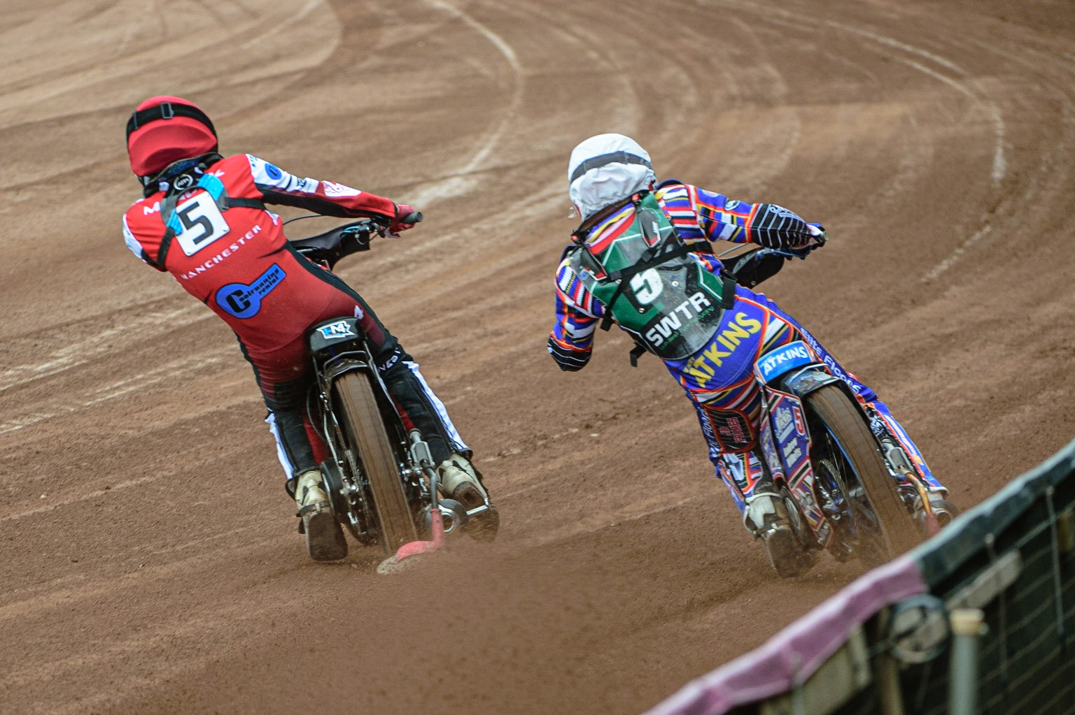 MANCHESTER, UK. APR 15TH  Harry McGurk  (Red) passes Henry Atkins  (White) on the inside  during the National Development League match between Belle Vue Colts and Plymouth Centurions at the National Speedway Stadium, Manchester on Friday 15th April 2022. (Credit: Ian Charles | MI News)