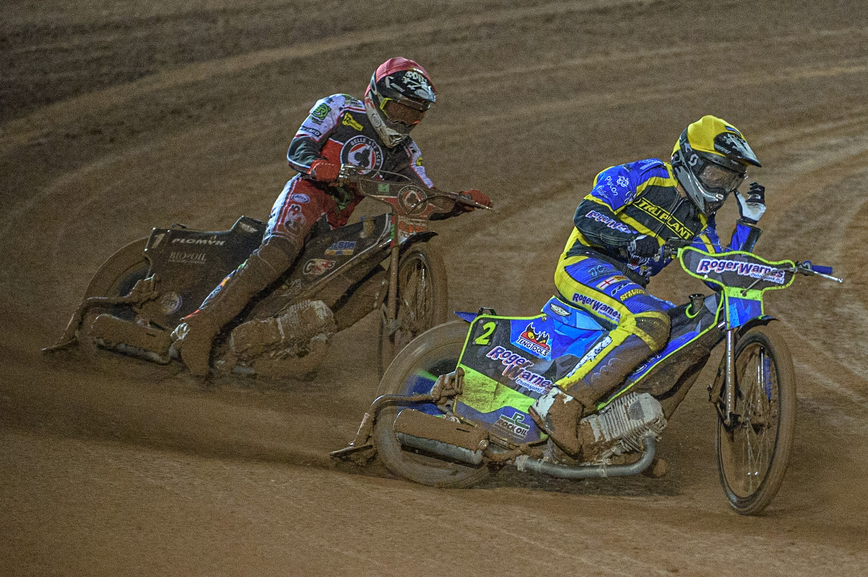 MANCHESTER, UK. OCT 7TH  Troy Batchelor  (Yellow) pulls off a tear off from his goggles ahead of Dan Bewley  (Red) during the SGB Premiership Play off Semi-Final Second Leg between Belle Vue Aces and Sheffield Tigers at the National Speedway Stadium, Manchester on Thursday 7th October 2021. (Credit: Ian Charles | MI News)