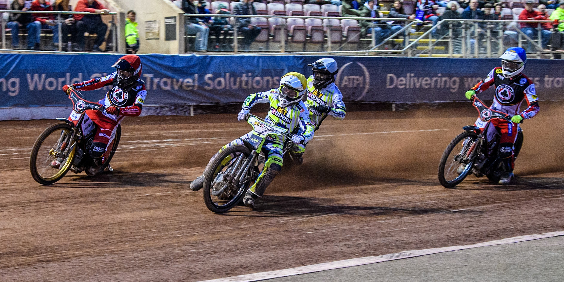 Belle Vue Aces' Norick Blodorn in Red rides outside Oxford Spires' Luke Killeen in Yellow with Oxford Spires' Erik Riss in White and Belle Vue Aces' Jake Mulford in Blue behind during the Rowe Motor Oil Premiership match between Belle Vue Aces and Oxford Spires at the National Speedway Stadium, Manchester on Monday 14th April 2025. (Photo: Ian Charles | MI News)
