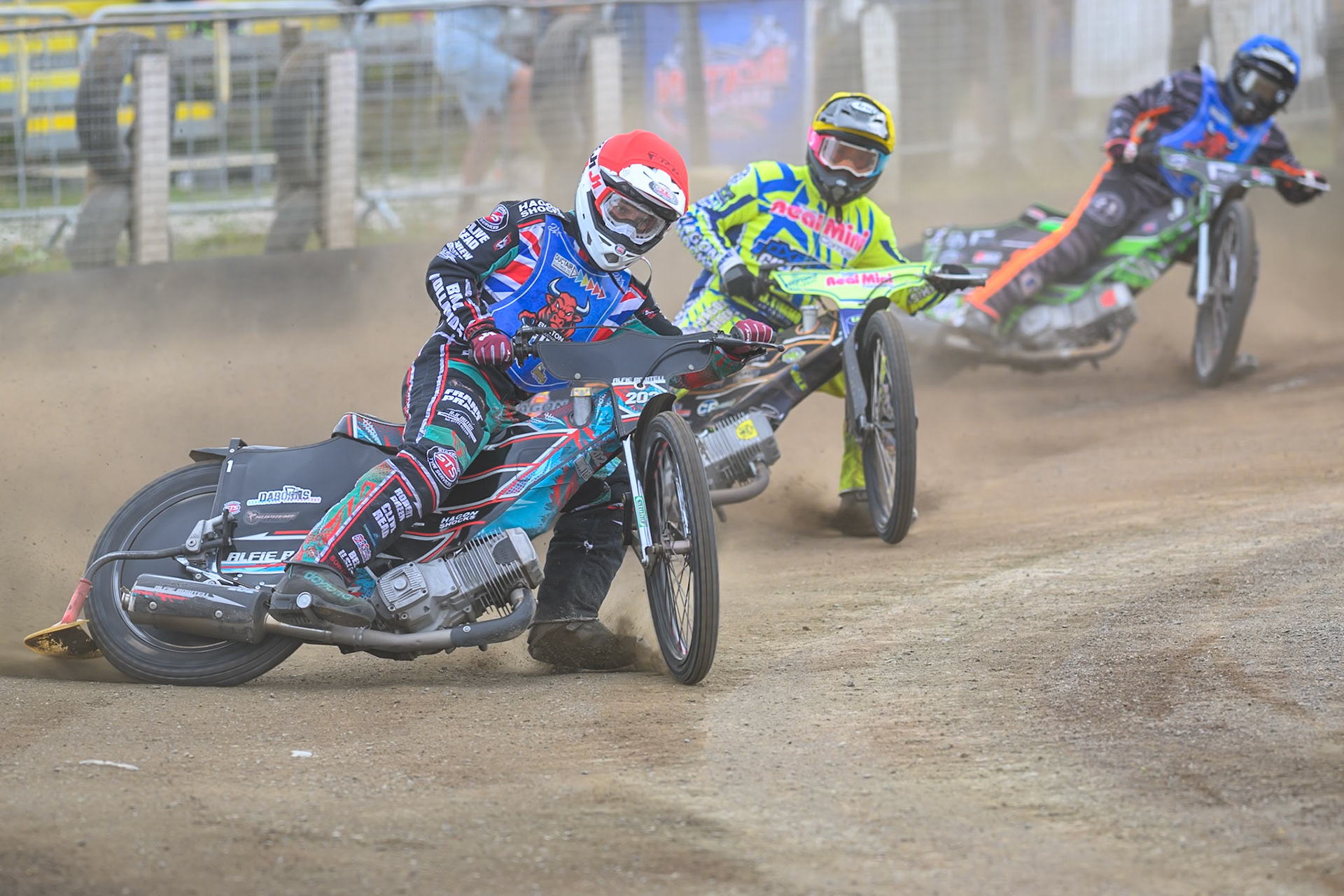 Alfie Bowtell of Buxton Bulls in Red leading Ashton Vale of Oxford Chargers in Yellow  and Jack Roberts of Buxton Bulls in Blue during the WSRA National Development League match between Buxton Bulls and Oxford Chargers at Hi-Edge Speedway, Buxton on Sunday 2nd August 2026. (Photo: Ian Charles | MI News)