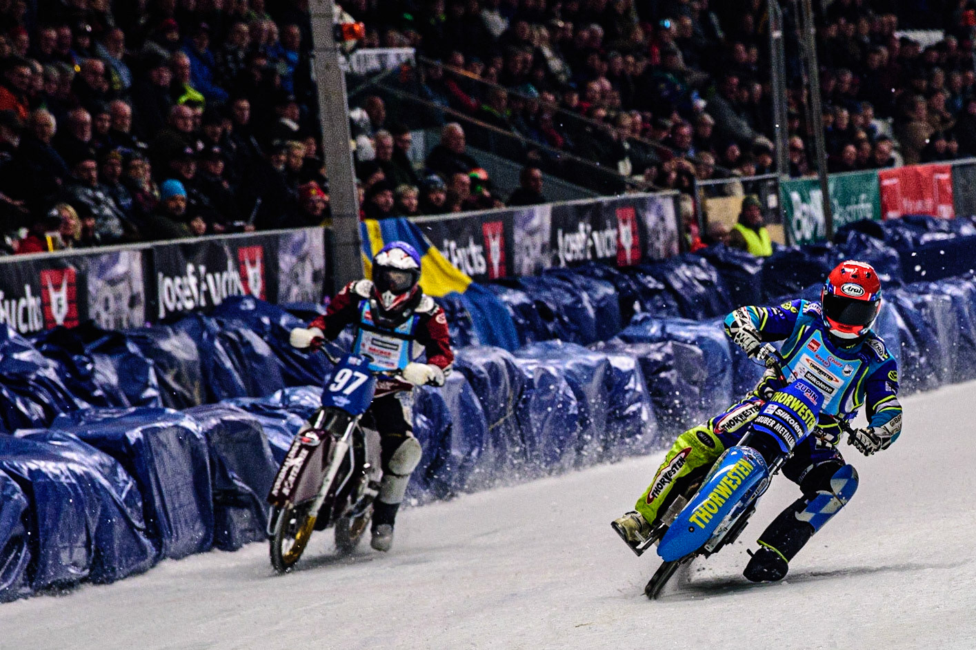 Günther Bauer (Red) passes Ove Ledström (Blue) during the Race of Legends at the Max-Aicher-Arena, Inzell on Friday 17th March 2023. (Photo: Ian Charles | MI News)