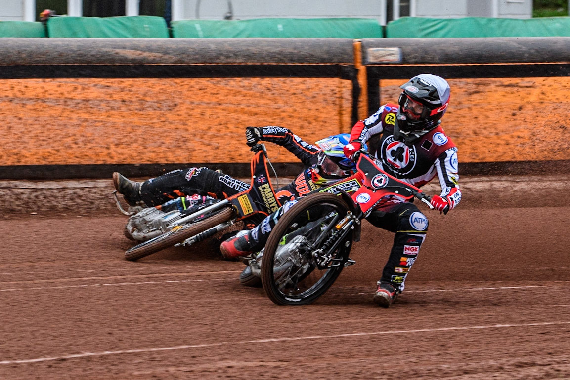 Tom Brennan (White) inside Leon Flint (Blue) as he falls in the first bend during the Sports Insure Premiership match between Wolverhampton Wolves and Belle Vue Aces at Monmore Green Stadium, Wolverhampton on Monday 10th July 2023. (Photo: Ian Charles | MI News)
