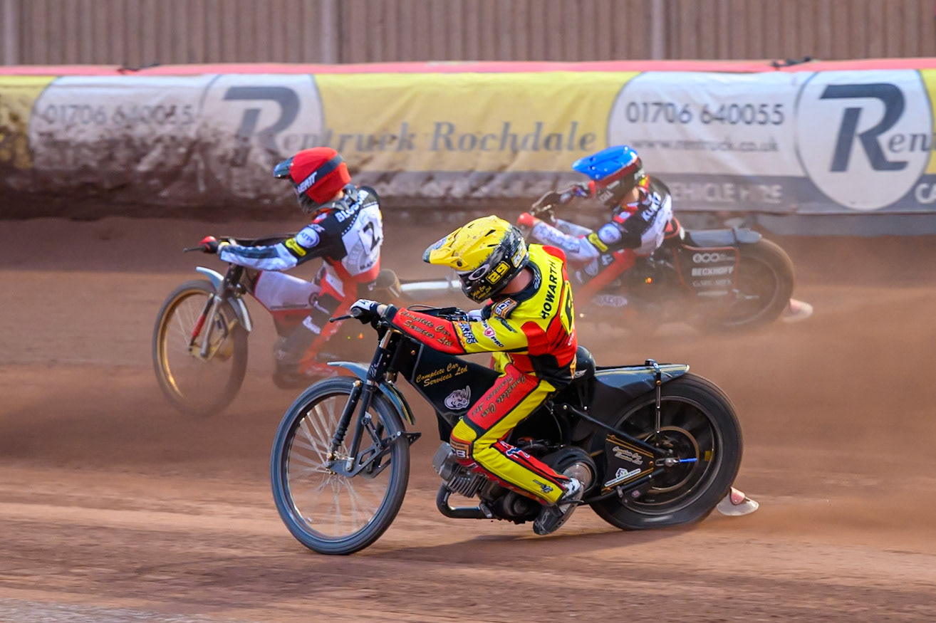 Kyle Howarth of Leicester Lions in Yellow rides inside Norick Blödorn of Belle Vue Aces in Red and Brady Kurtz of Belle Vue Aces in Blue during the Rowe Motor Oil Premiership match between Belle Vue Aces and Leicester Lions at the National Speedway Stadium, Manchester on Monday 15th June 2026. (Photo: Ian Charles | MI News)