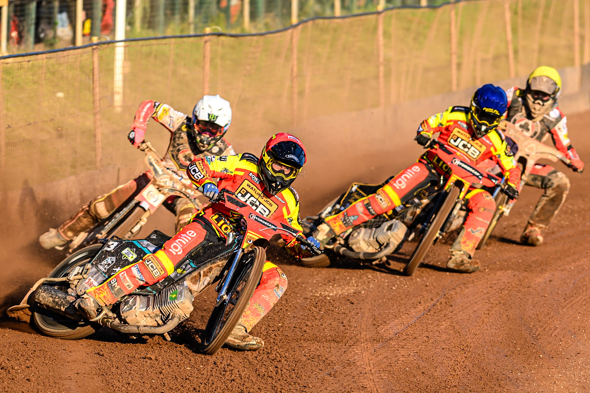 Leicester Lions' Ryan Douglas in Red leading Belle Vue Aces' Dan Bewley in White, Leicester Lions' Kyle Howarth in Blue and Belle Vue Aces' Norick Blodorn in Yellow during the Rowe Motor Oil Premiership match between Leicester Lions and Belle Vue Aces at the Hydroscand Arena, Leicester on Thursday 19th June 2025. (Photo: Ian Charles | MI News)
