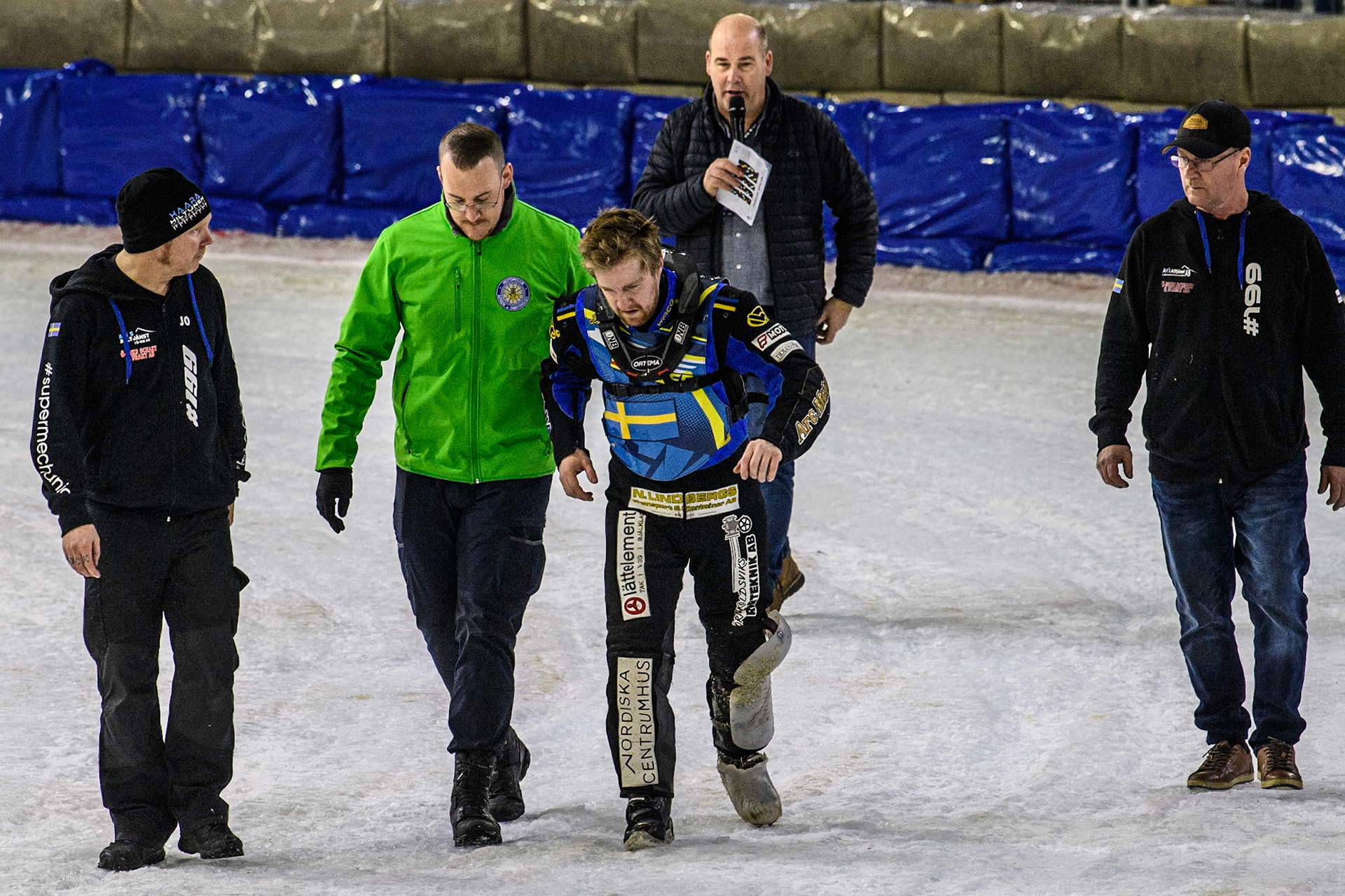 Sweden's Martin Haarahiltunen (Centre) is helped off after his crash in the final during the FIM Ice Speedway Gladiators World Championship Final 4 at Ice Rink Thialf, Heerenveen on Sunday 7th April 2024. (Photo: Ian Charles | MI News)