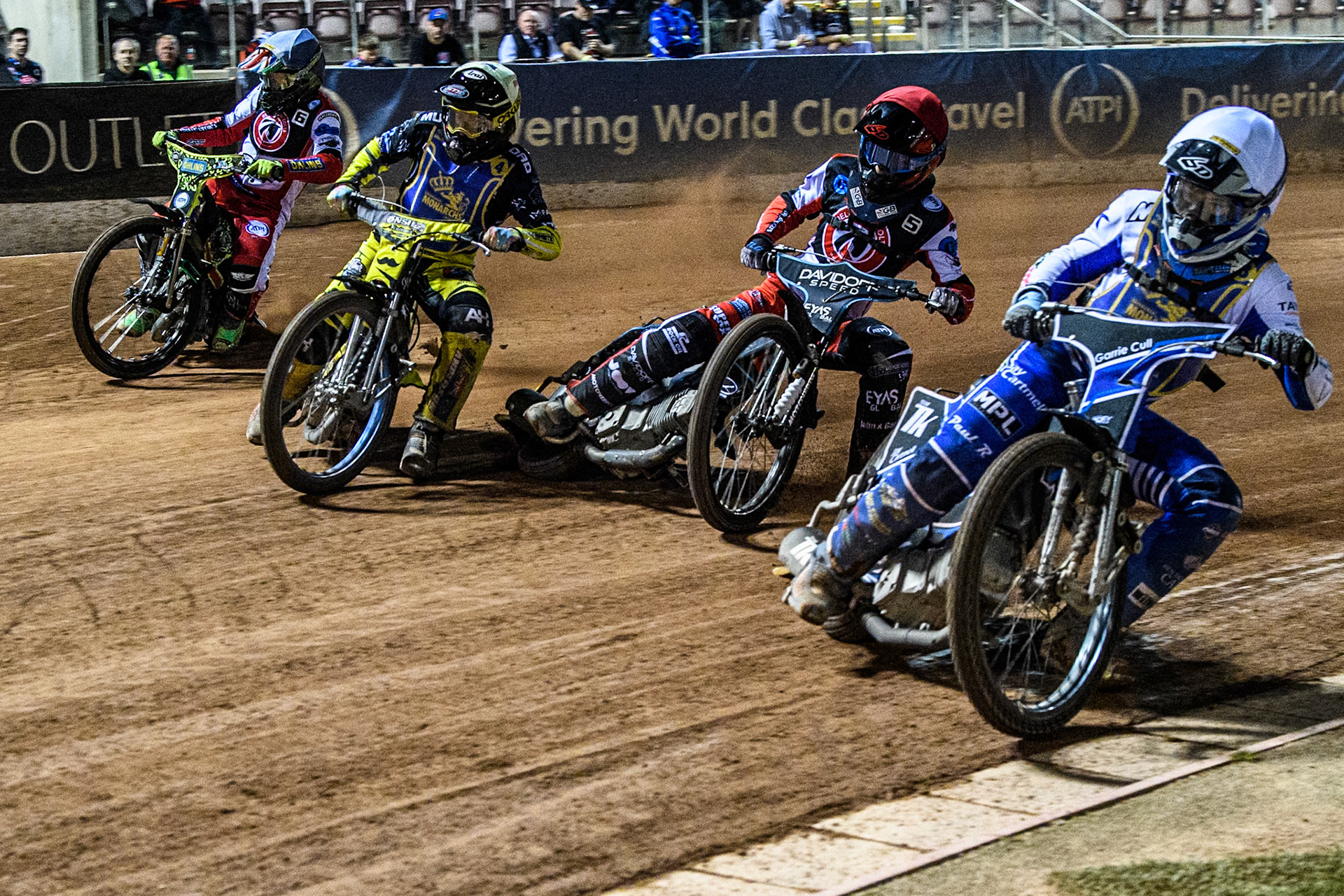 Edinburgh Monarchs' Sam McGurk in White rides inside Belle Vue Colts' Freddy Hodder in Red, Edinburgh Monarchs' Dayle Wood in Yellow and Belle Vue Colts' William Cairns in Blue during the WSRA National Development League match between Belle Vue Aces and Edinburgh Monarchs at the National Speedway Stadium, Manchester on Friday 30th August 2024. (Photo: Ian Charles | MI News)